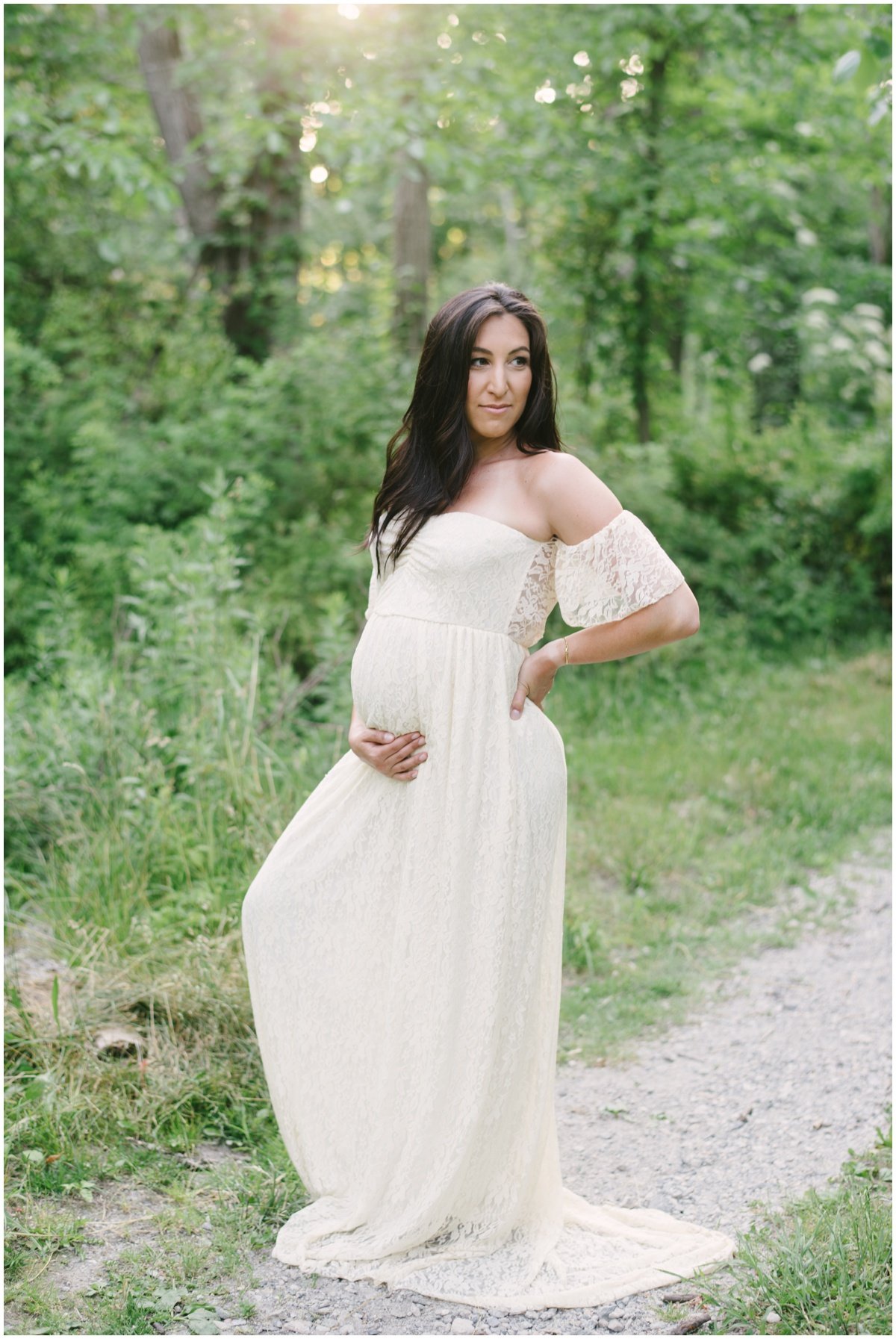 Woman wearing long white flowy dress during maternity session | NKB Photo