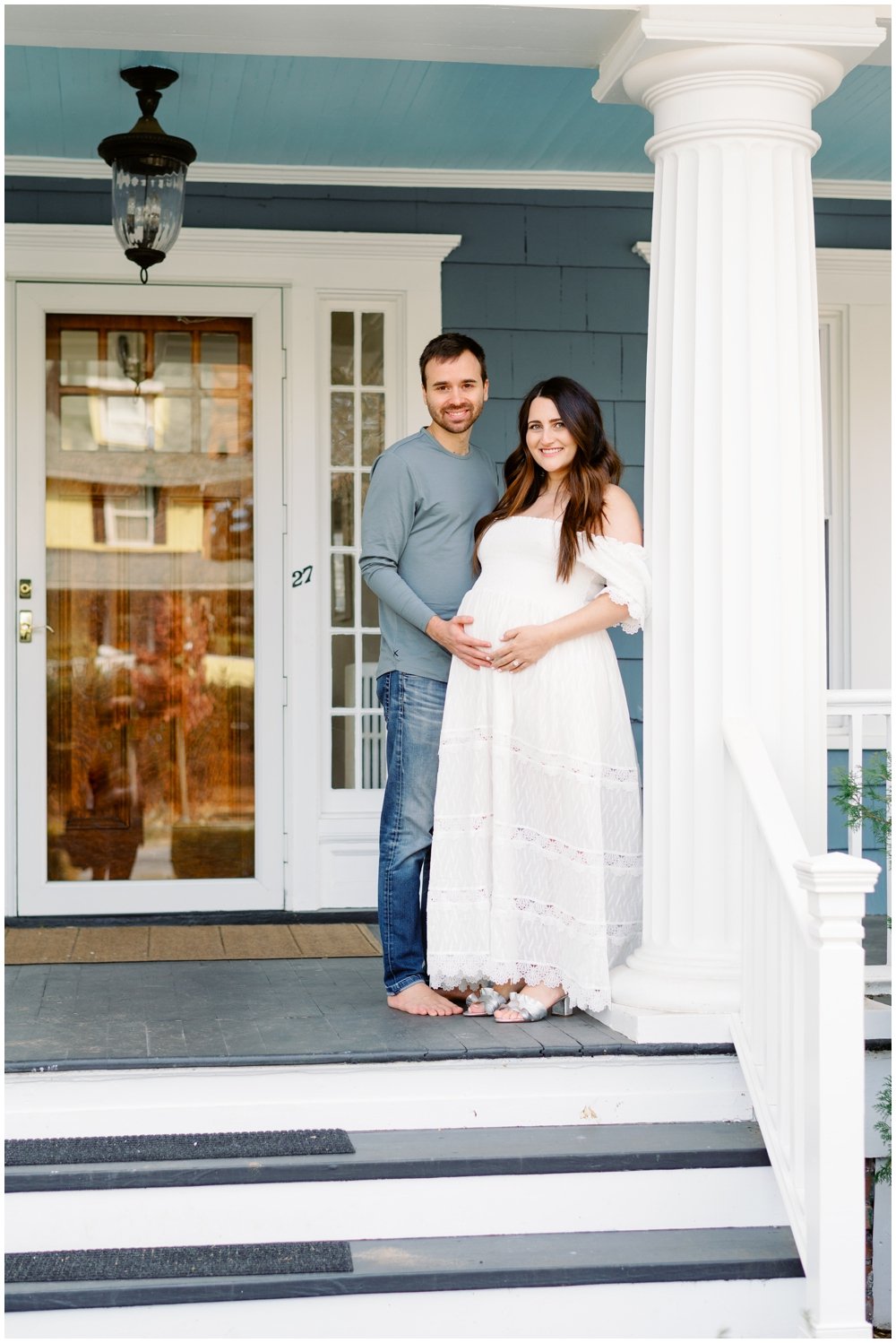 Parents standing on front porch during maternity session with West Palm Beach maternity photographer | NKB Photo