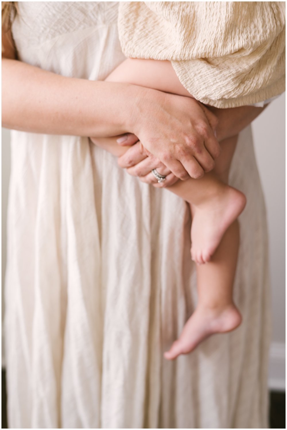 Mom holding oldest daughter during newborn session | NKB Photo