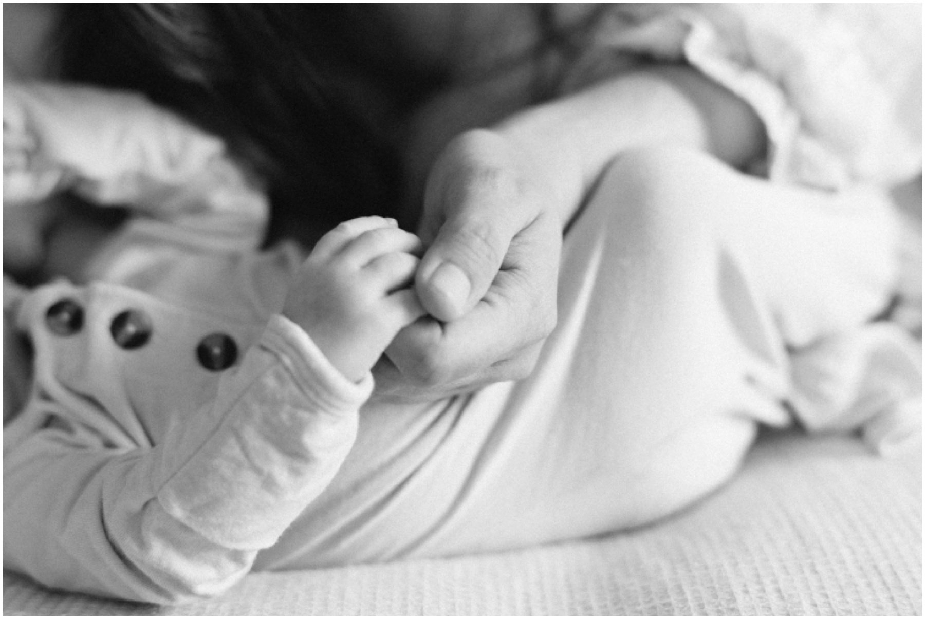 Newborn holding mom's hand during Florida milestone photography session | NKB Photo