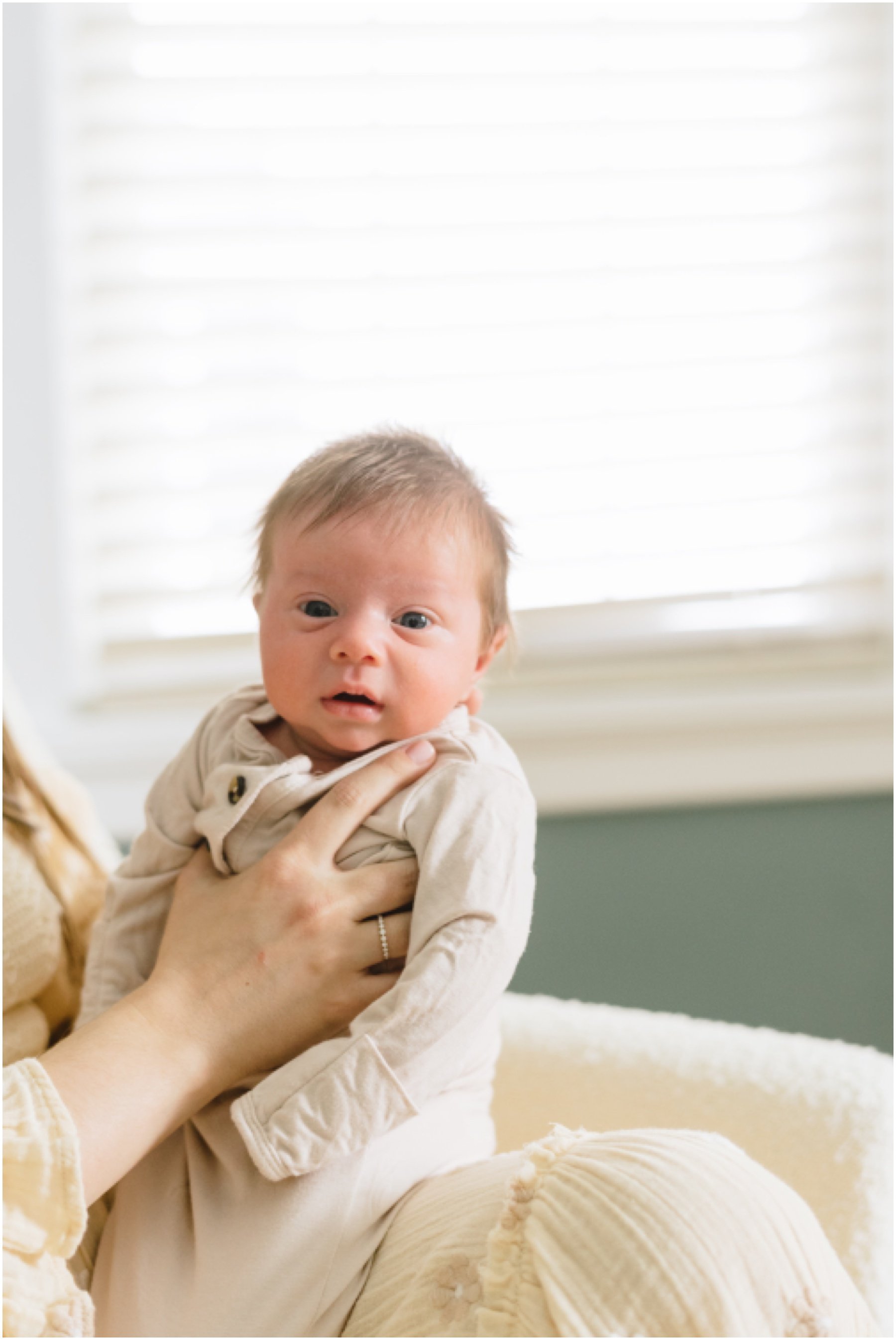 Newborn sitting up and looking at camera during Florida milestone photography session | NKB Photo