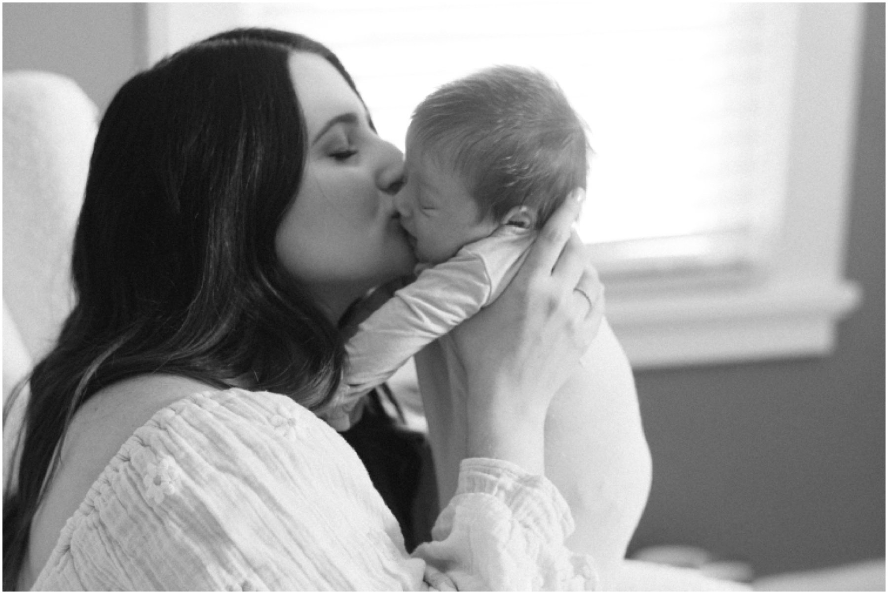 Mom kissing newborn during Florida milestone photography session | NKB Photo