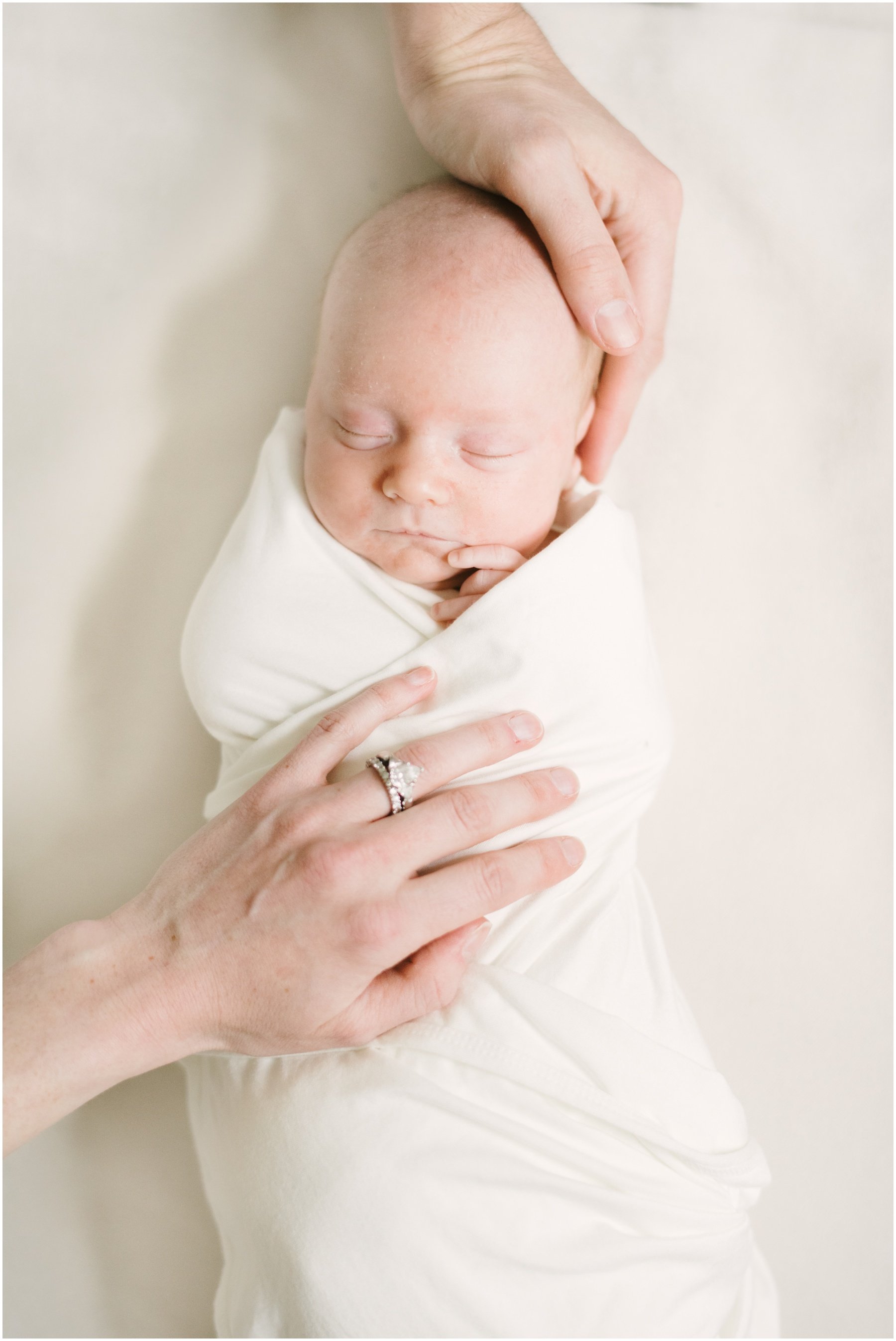 Baby wrapped in swaddle during newborn session | NKB Photo