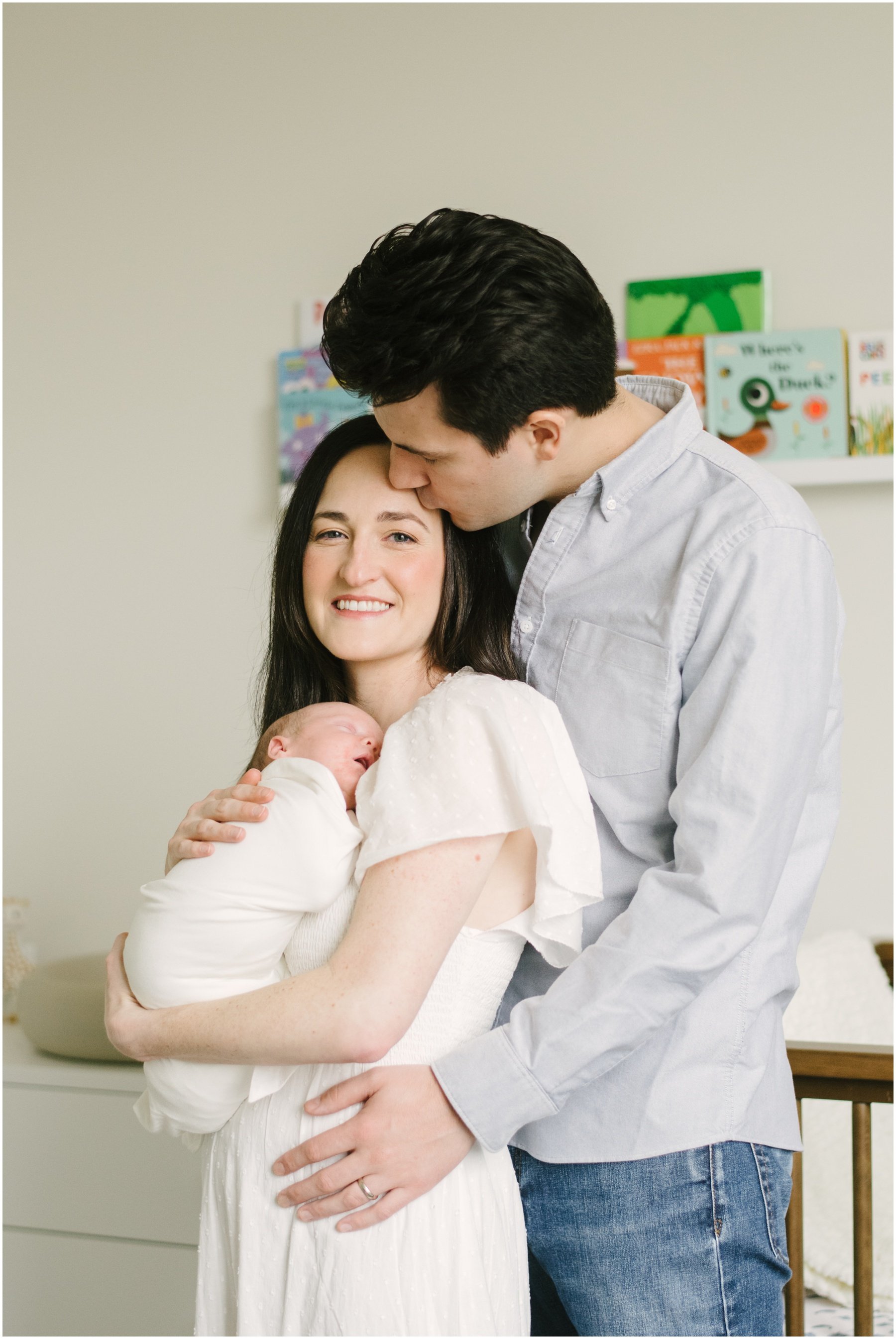 Dad standing behind mom and baby during newborn session | NKB Photo
