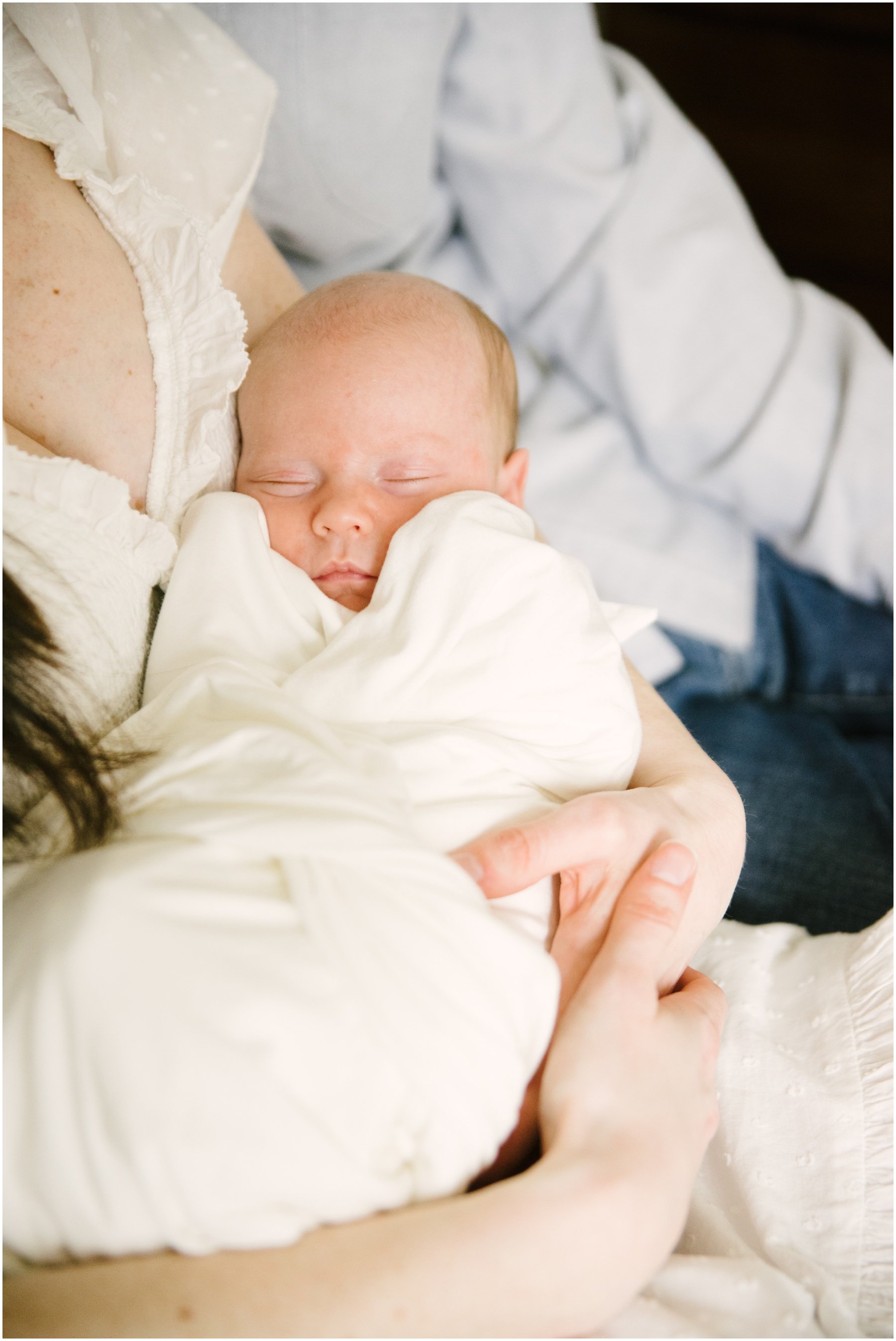 Sleeping baby being held by mom during newborn session | NKB Photo