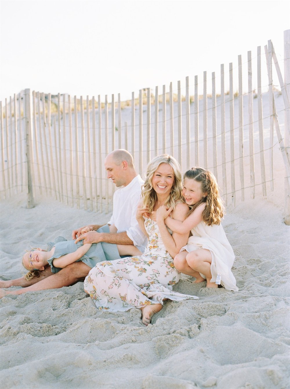 Family sitting on beach during Florida family beach photo session  | NKB Photo