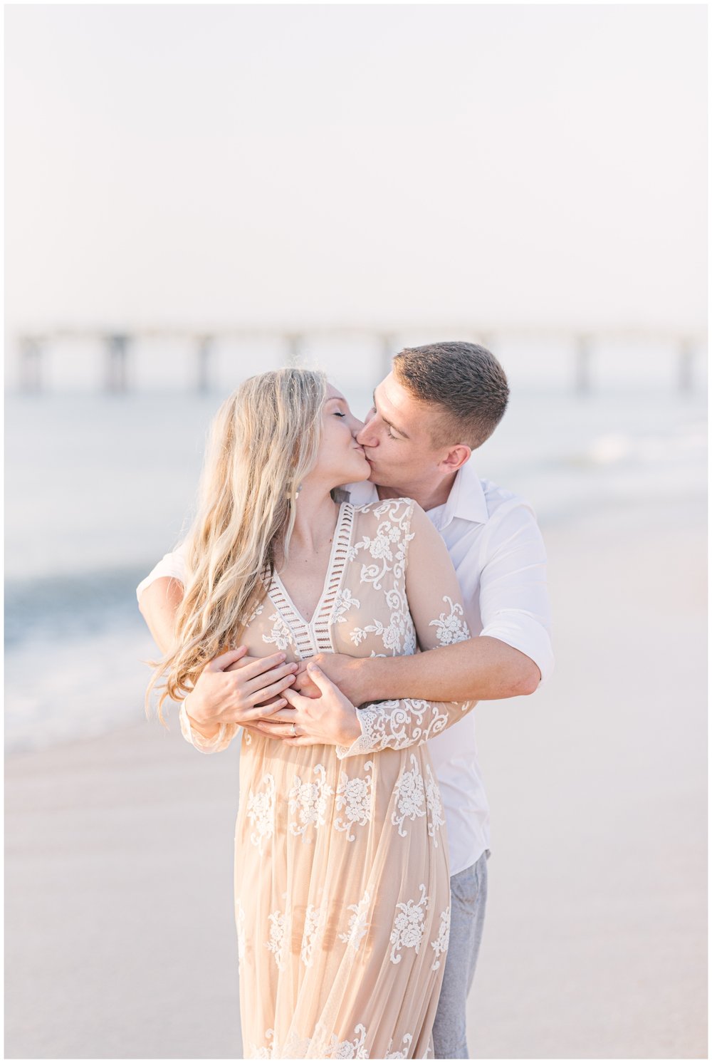 Couple kissing on beach during engagement session with family beach photographer | NKB Photo