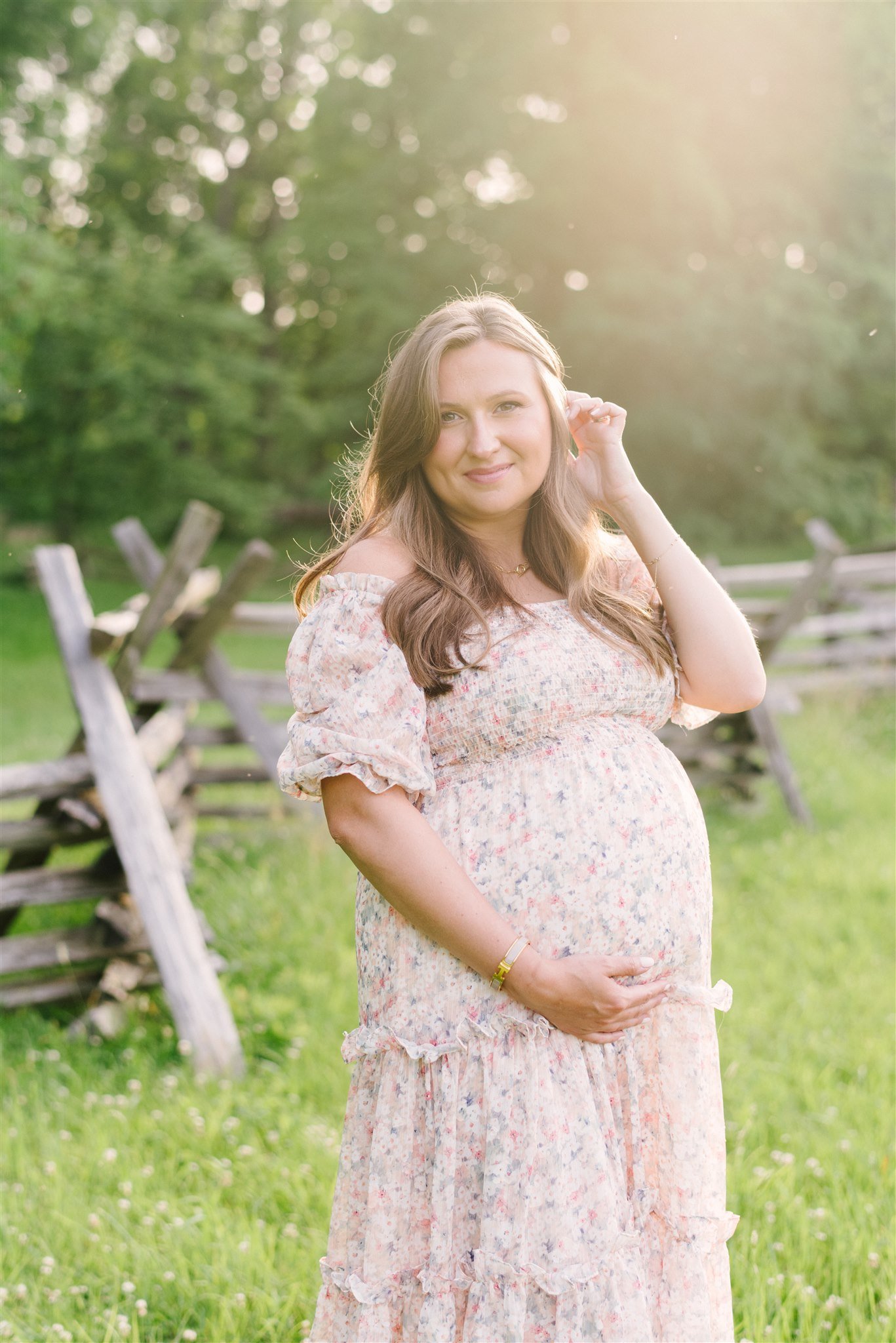 Pregnant woman cradling belly during session with Miami maternity photographer