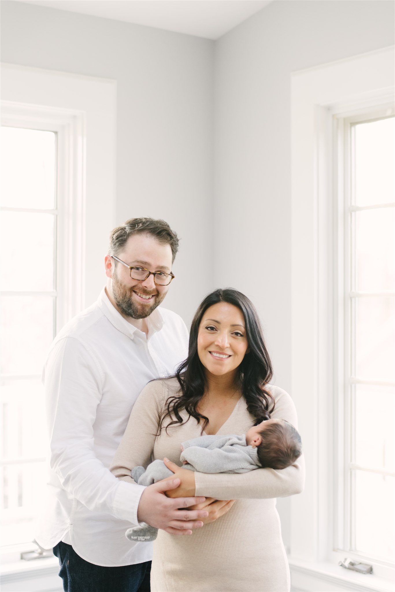 Mom and dad holding newborn during session with West Palm Beach newborn photographer