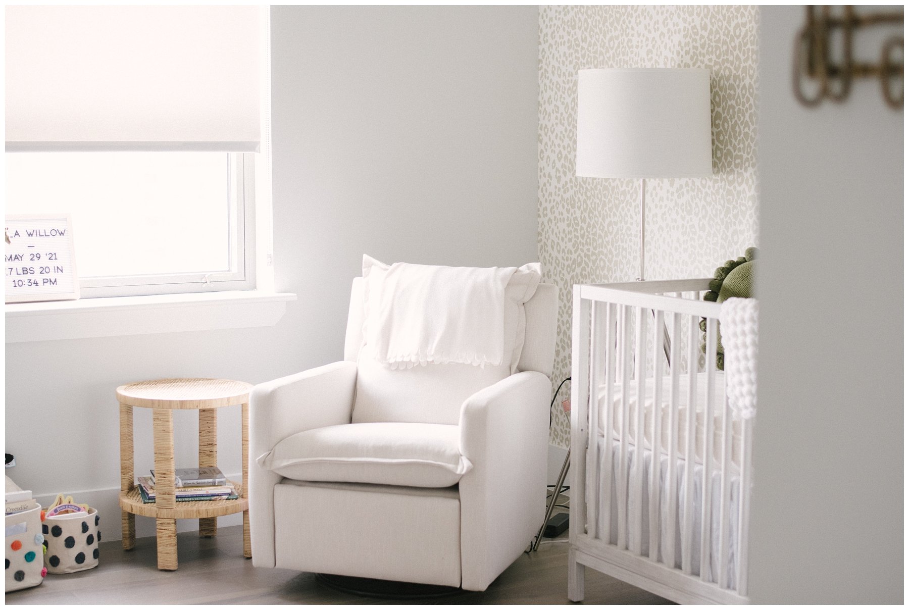 White glider and white crib with white and tan leopard print wallpaper by Fort Lauderdale photographer | NKB Photo