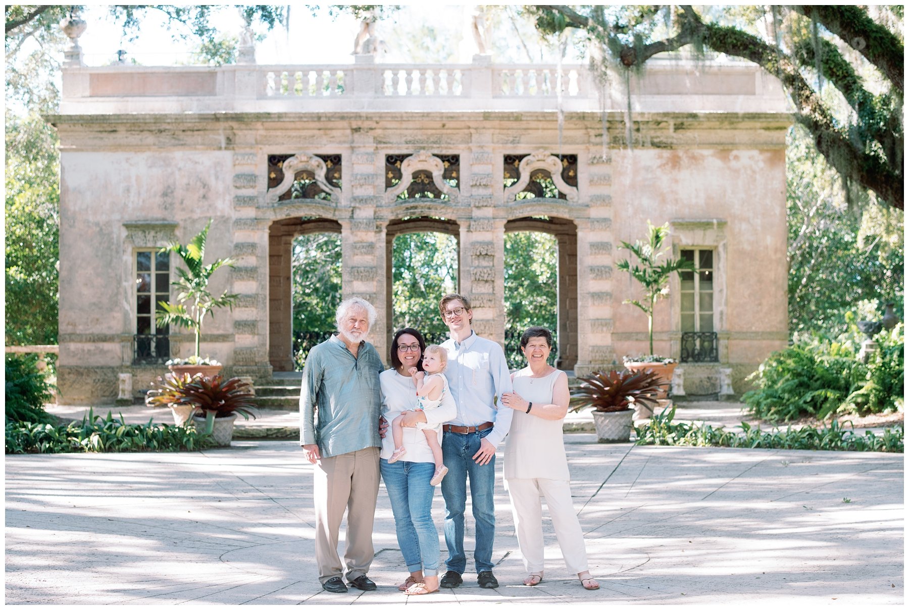 Family standing in front of arches at Vizcaya during session with Miami photographer | NKB Photo