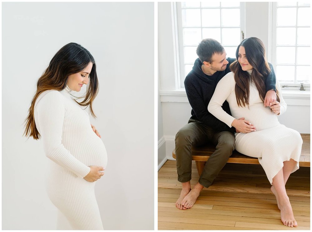 Woman wearing white dress cradling pregnant belly | husband and wife sitting on bench during maternity session at home | NKB Photo
