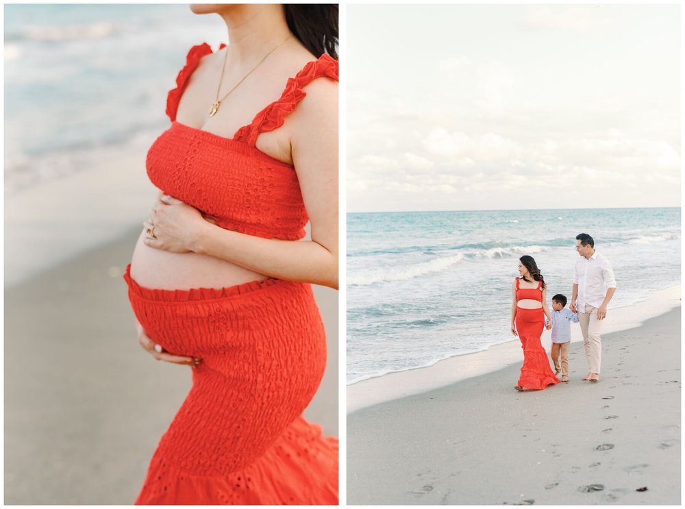 Woman wearing two piece red outfit for maternity session on beach | mom, dad, and son holding hands and walking on beach during maternity session | NKB Photo