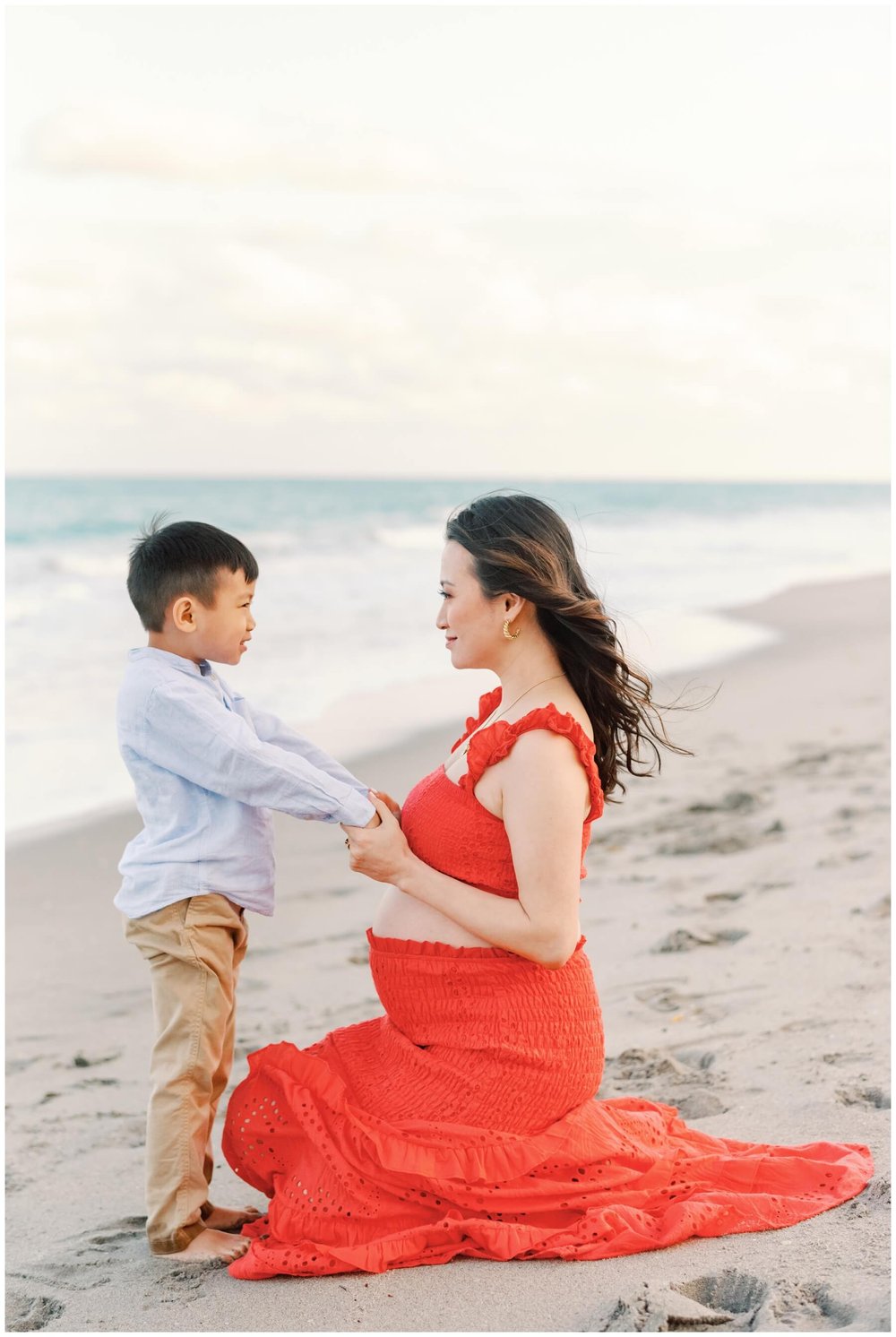 Mom holding son's hands and looking at him during session with maternity photographer in Miami | NKB Photo