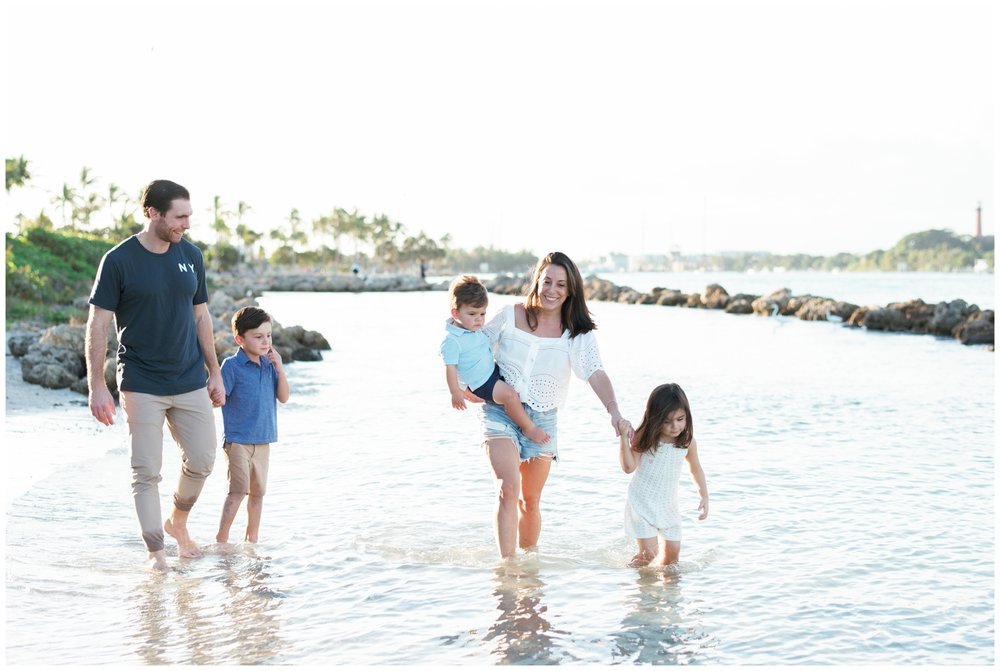 Family walking in the water on beach in Jupiter, FL | NKB Photo