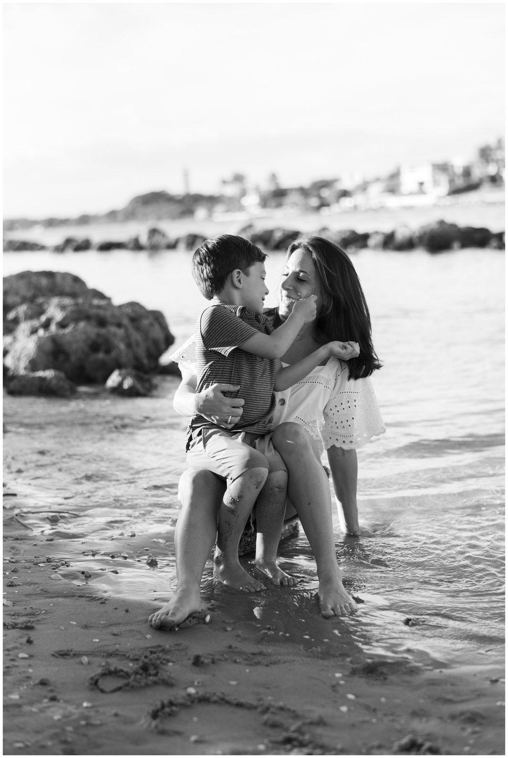 Mom holding young boy on beach during family session | NKB Photo