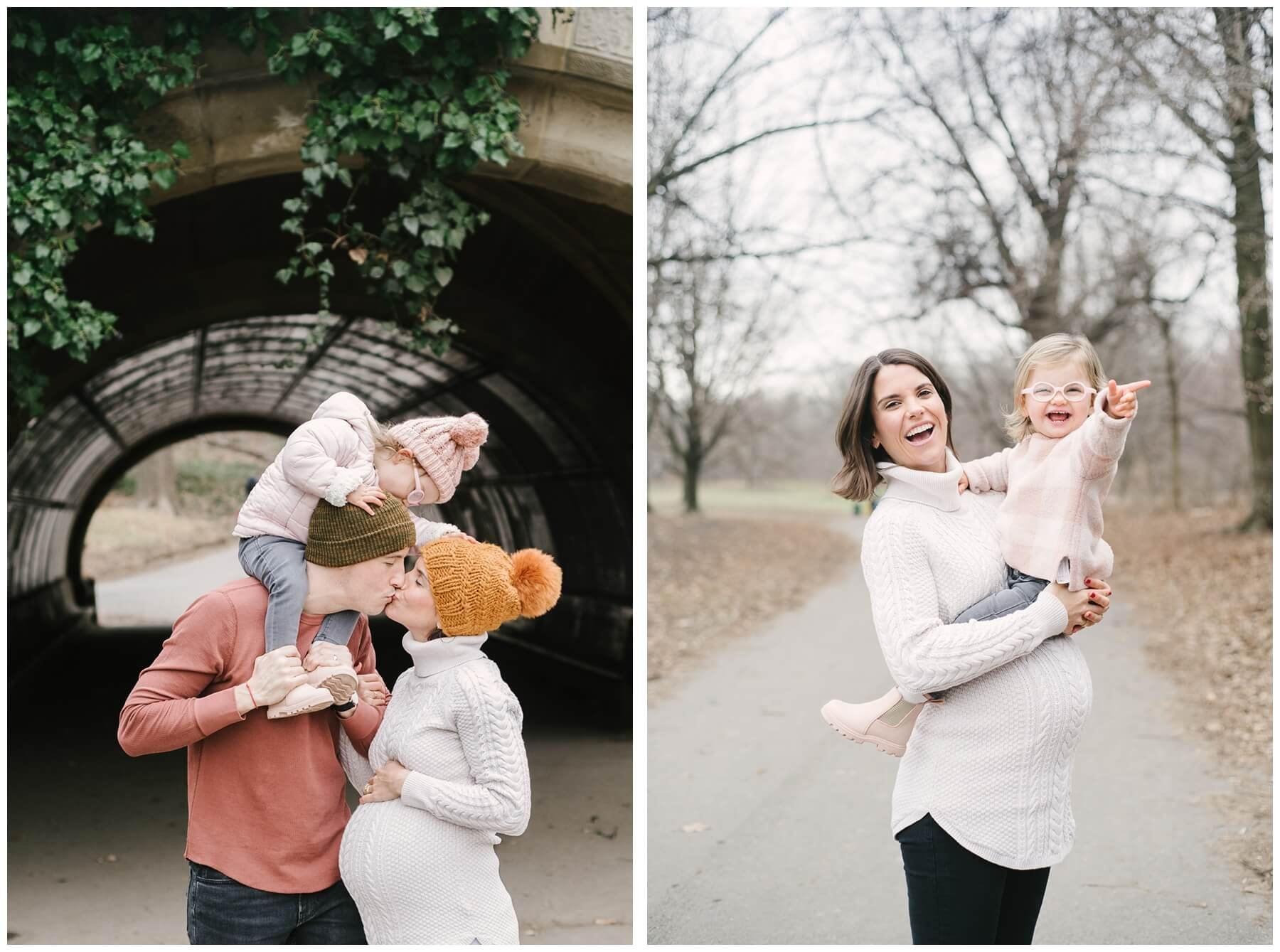 Toddler looking down at parents from dad's shoulders while parents kiss | pregnant mom holding toddler while she laughs in session with NKB Photo