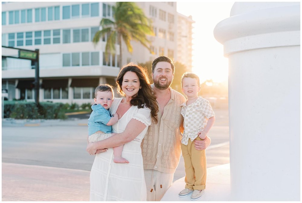 Mom and dad with two young sons during shoot on beach with Fort Lauderdale family photographer | NKB Photo