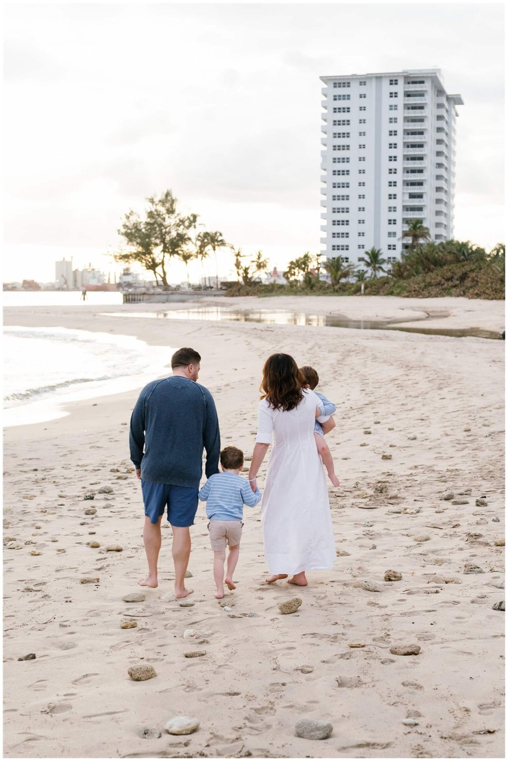 Family with two young boys walking on beach in Fort Lauderdale