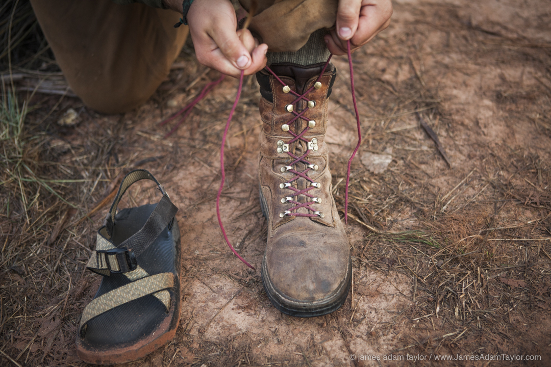 Crew Leader James Shaw laces his boots in preparation for the day.
