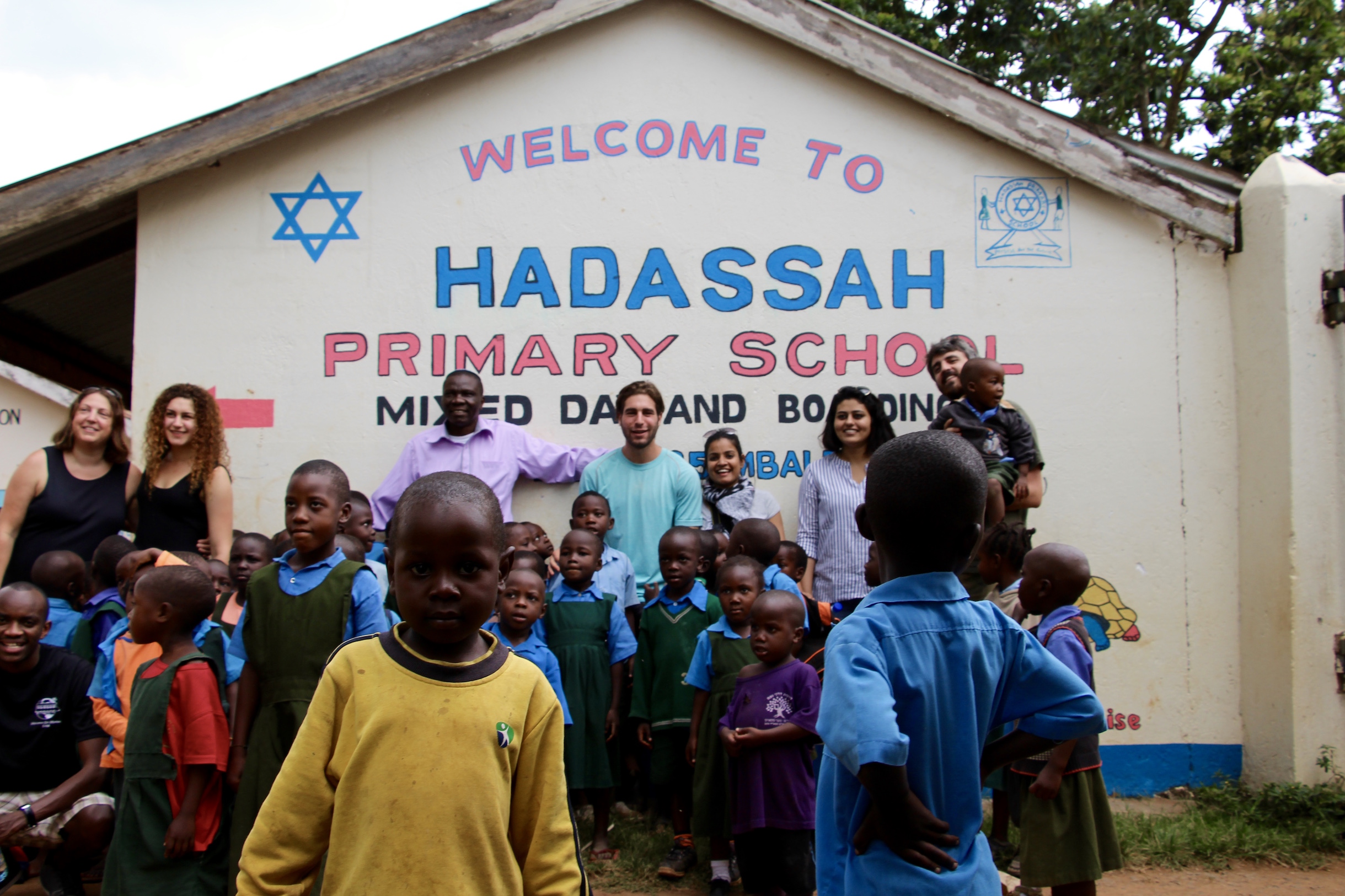 Photo (from left to right) of Ally, Lainie, Eli, Aaron Kintu Moses (Headmaster of Hadassa Elementary School), Aaron, Ruchi, Sukriti, and Leonard. 