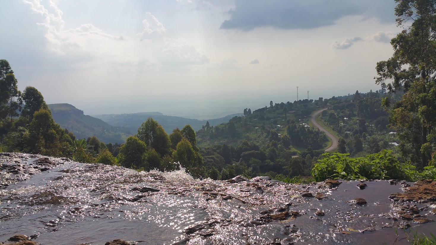 Standing above Sipi Falls overlooking the lush country side. 