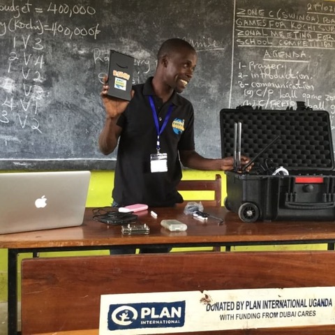 TWSB Uganda Technology Coordinator, Sadati Mulilo. training Alaba Primary School teachers on the resources available in the BrightBox Micro.