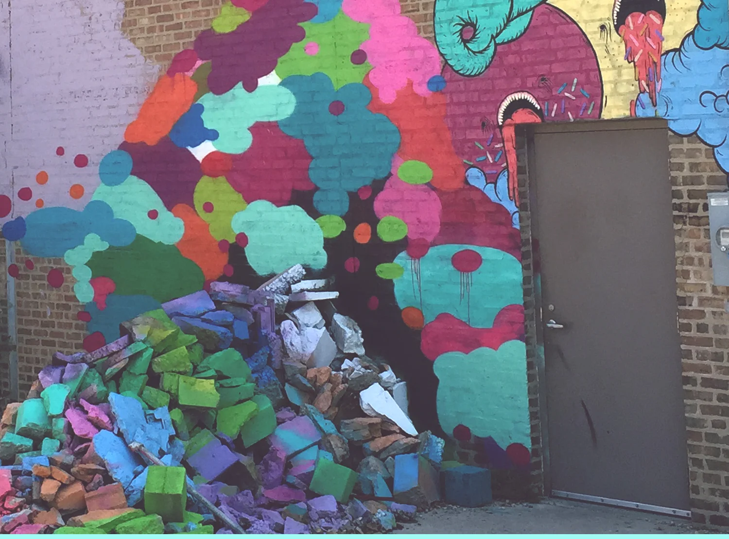 Color Me Crumbled , Center for the Lost Arts, founded by Charles Adler of Kickstarter, Chicago, Illinois. "This was just an impromptu installation. When working on a mural on the other side of the building, I had a lot of scrap cans, (and) the pile of rocks was just sitting there. When I start a project, I'll sit at the location for hours doing nothing. Not thinking, not planning—just doing nothing. I can say it's part of the process and in a way it is, but mostly it's procrastination. I'll find random things to keep me busy, except what I'm there to do. So I just started painting those rocks. The funny thing is, that pile of pukey rocks got more attention and praise than the 75-foot-long mural on the other side." 