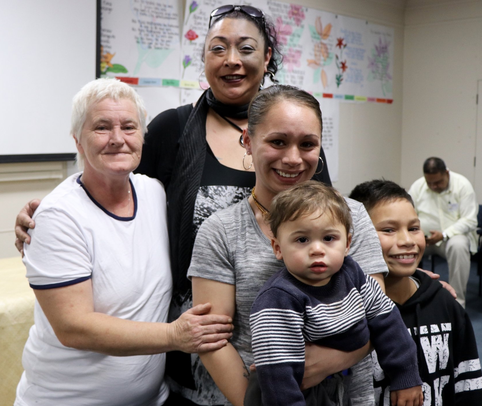 Michelle (front centre), with her mum (left), her social worker Maria (back centre) and two of her children