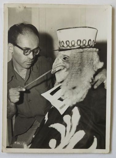Louis Kahan with mask - Despina (Nancy Rasmussen) disguised as a lawyer, Cosi fan tutte , National Theatre Opera Company, Melbourne, 1953. Kahan Family Collection.