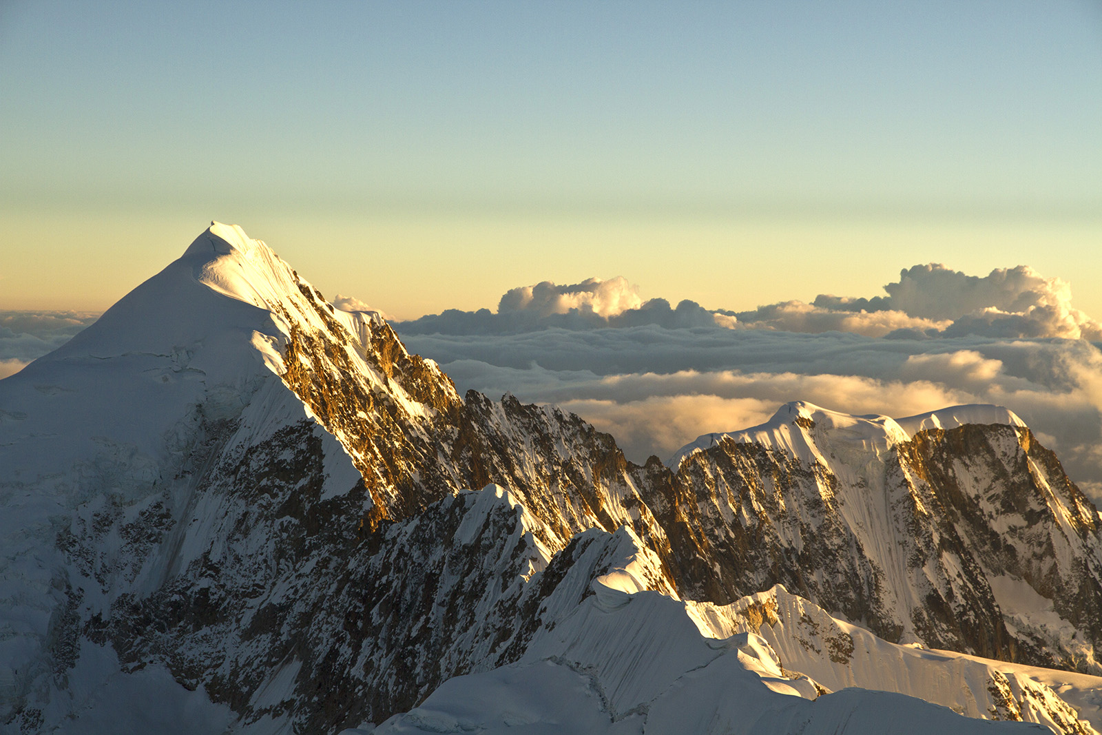 Illampu (6.360m/20,866ft.) during sunrise in the Cordillera Real, Bolivia. Shot taken from the summit of Ancohuma (6.427m/21,086ft). 