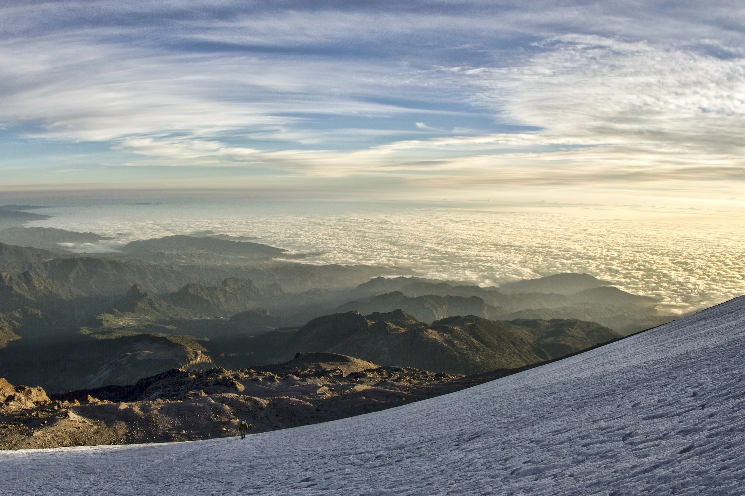 Dawn breaks as we unstrap the crampons and ice axes from our packs. Low clouds sweep inland from the Gulf of Mexico only for their advance to be halted by the Cordillera Neovolcánica, on which we stand.