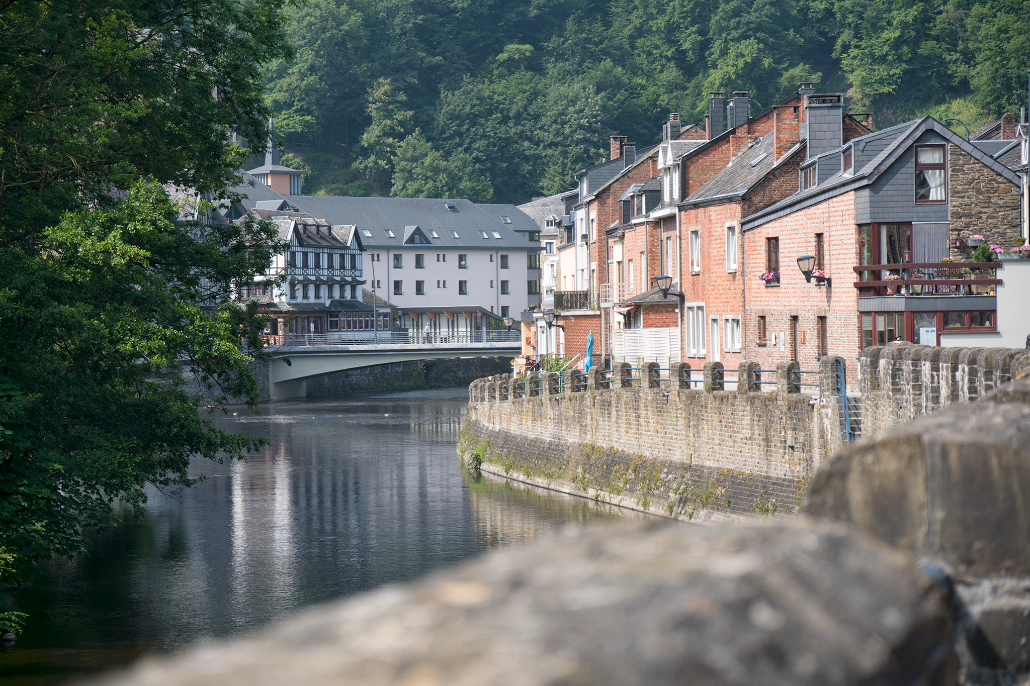  When I reach La Roche-en-Ardenne, I lock my bike outside a store and head inside to resupply and escape the stifling midday heat. At the end of one of the store aisles an older man wearing a beret stands with a lazy grin on his face and one hand in 