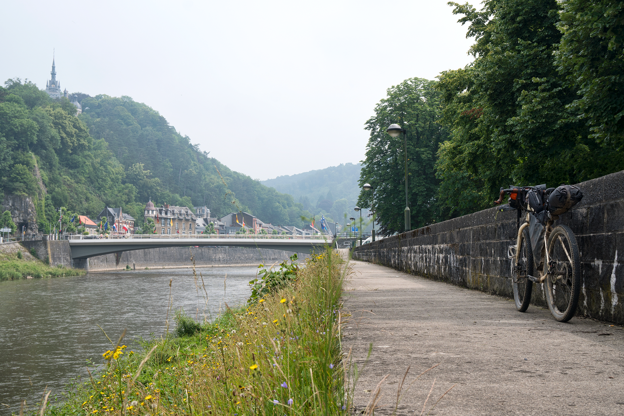 I pop out of the forest onto the banks of the Ourthe river, 15 kilometers south of Liège. A paved cycle path, the RV7, follows the meandering river into the heart of the city where the best gaufres on the planet can be found. I pick up speed and begin eating away at the distance, shifting up in my gears methodically, barely noticing the striking silhouette of a chateau presiding over the treetops. A comforting hum emanates from my knobby tires gripping the asphalt surface as I click into the highest gear. My hands are tucked into the crook of the dropbars with elbows slightly bent and head down. My breaths are deep and gratifying, bringing oxygen to the muscles that have been tuned for this exact purpose. The hum from my tires is now a constant wail, the soundtrack to my re-entry into civilization. One by one, I feel my systems escaping their stases. Oxygen delivery, blood circulation, muscle processes, power transmission, pedal stroke, and body position all harmonizing to liberate the ultimate component of my being: my mind. For several kilometers, I achieve the coveted state of flow whereby the totality of my essence is consumed by the uninterrupted firing of systems operating with the singular purpose of manifesting my will. The journey is closing and I enter Liège fulfilled by its finality.