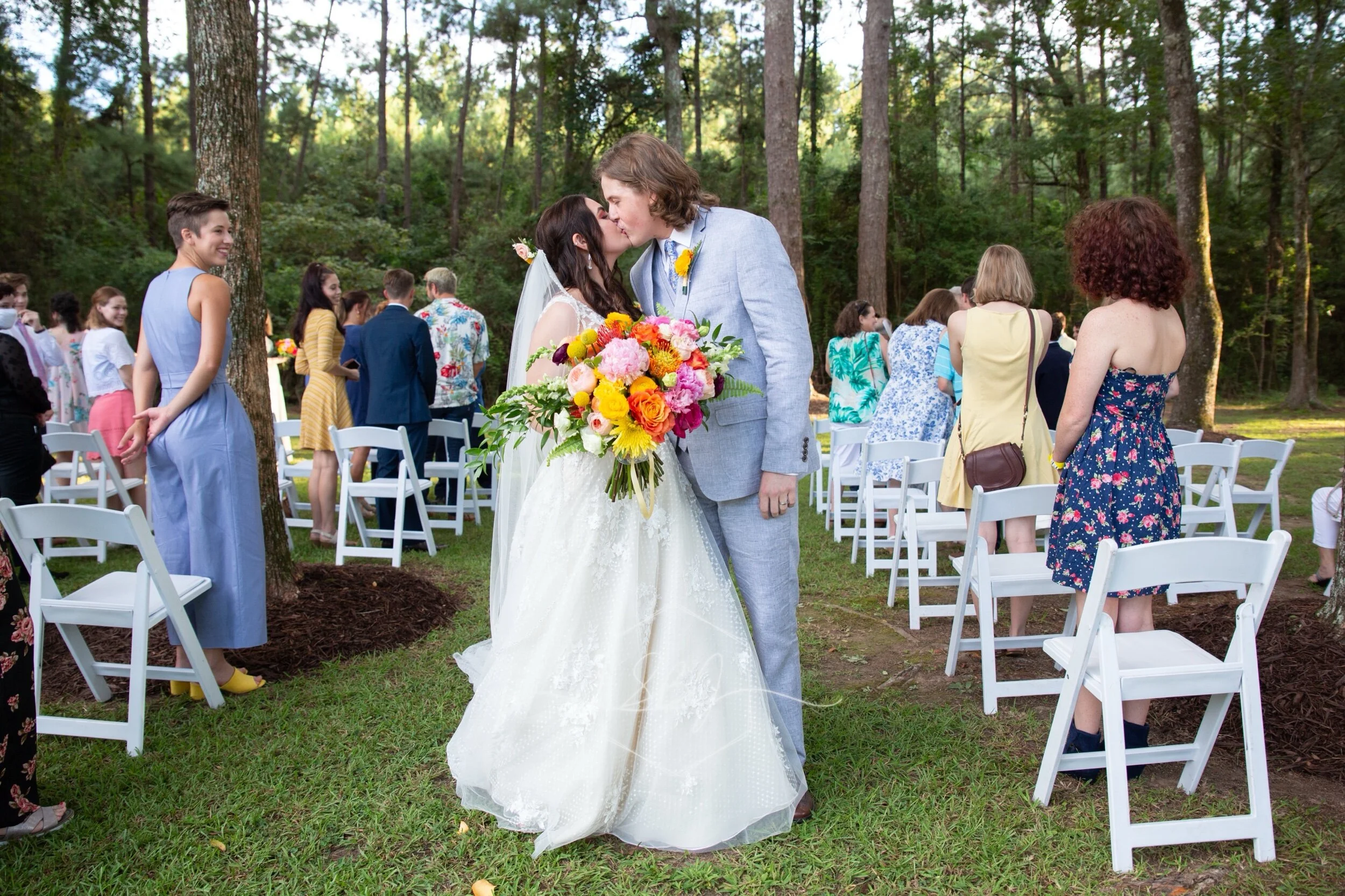 Wedding photography baton rouge new orleans backyard bride groom photographer photography videography photo booth louisiana bridal portrait the sentimental petal bouquet florals flowers infinity circular Arch arbor first kiss