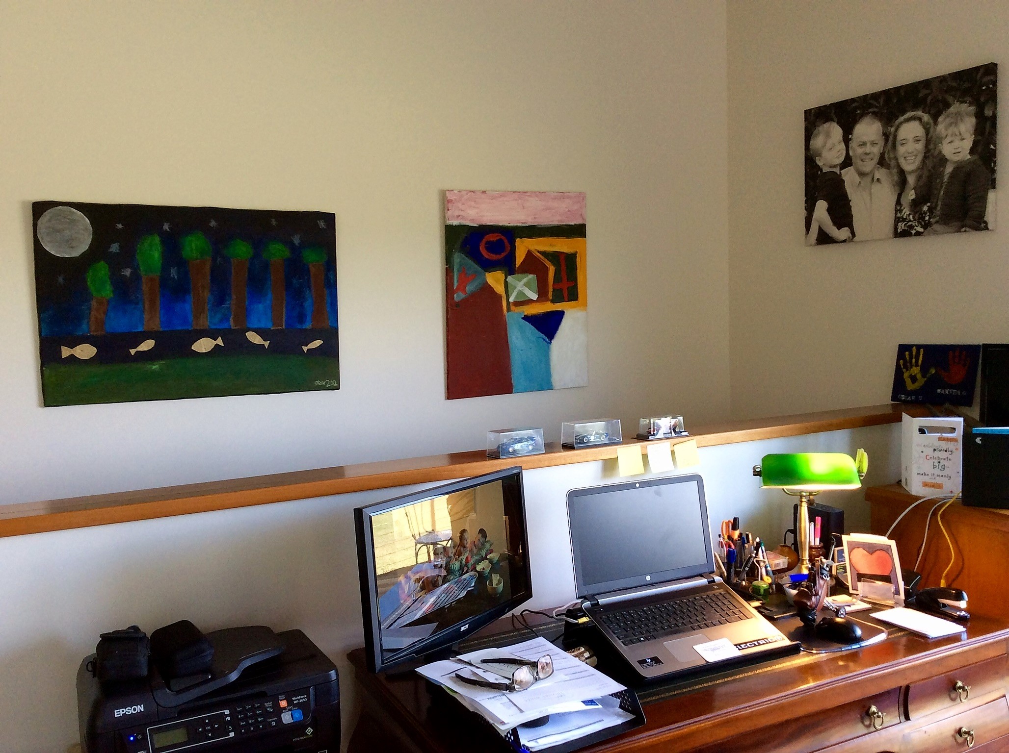 Our home office with the boys artworks displayed on the wall.