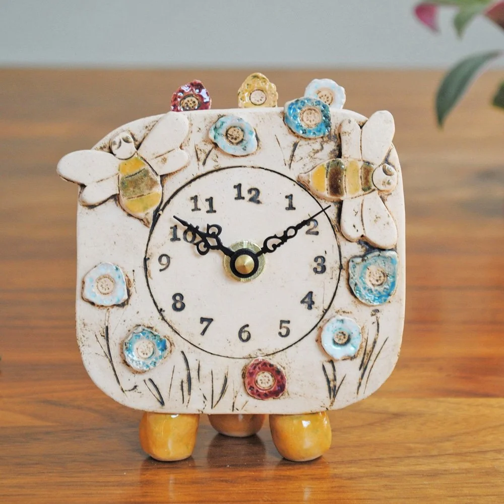 Fish shoal mantel clock with pebble feet. — Surrey Guild of Craftsmen