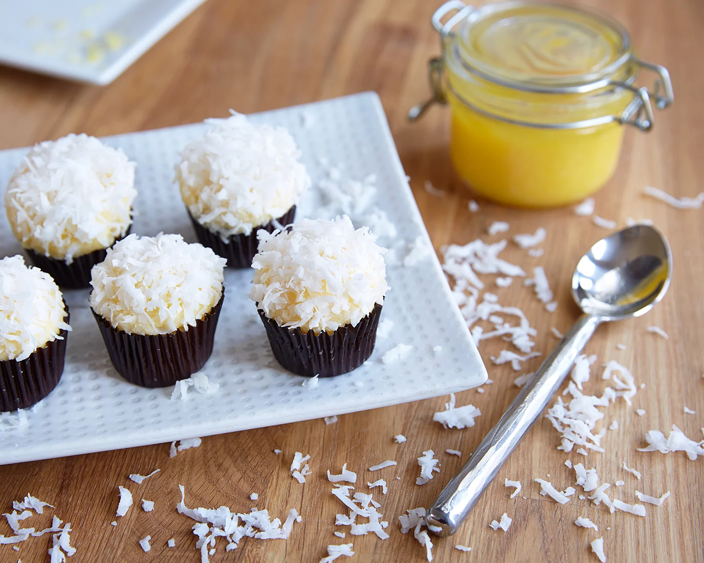CoCoNut Citrus infused yellow cake with Lemon curd buttercream topped with sweet shredded coconut flakes