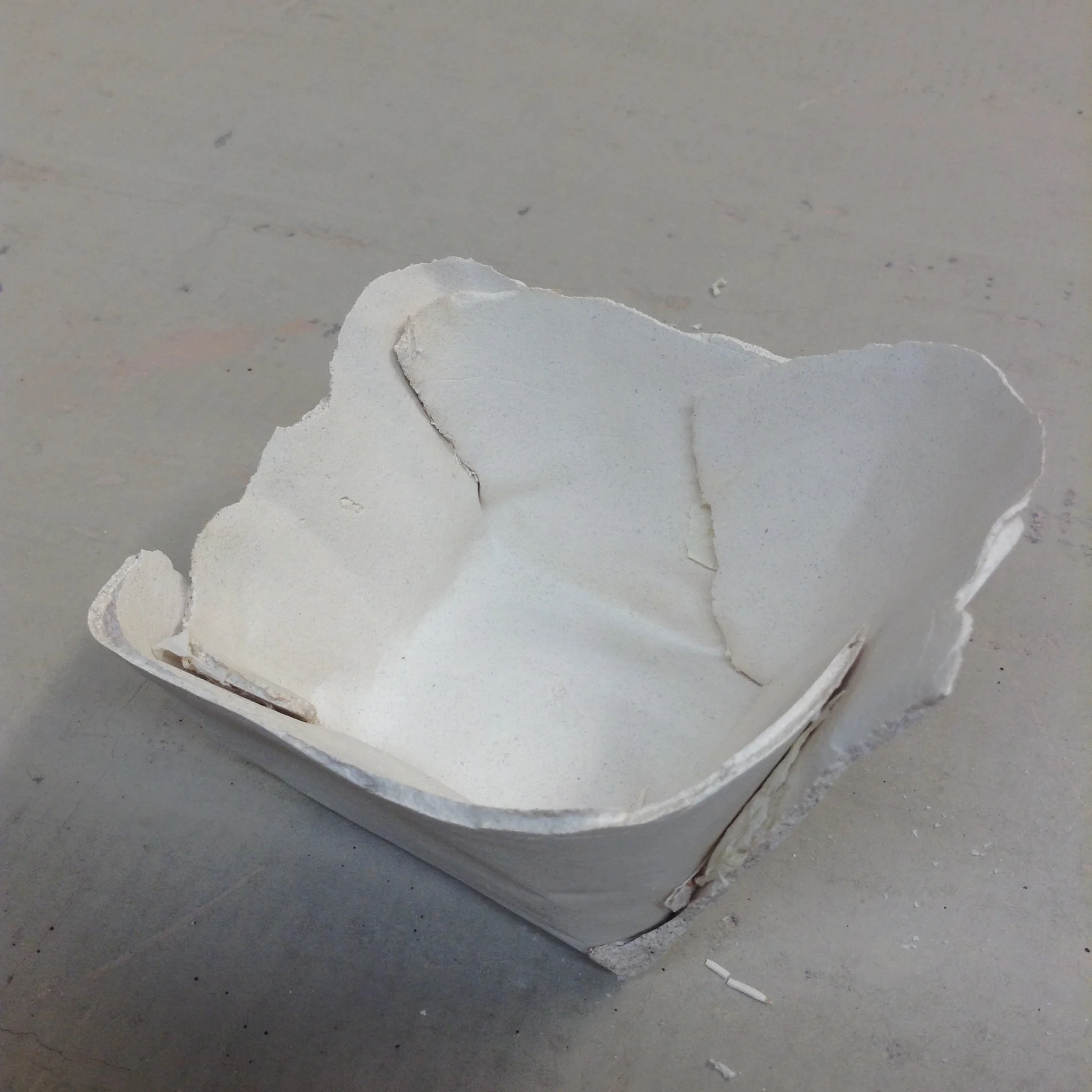 The completely fired bowl form with cut overlapped edges easily seen inside and out. The upper edge of the bowl is unchanged from the edges that happened when the slip was spread on the newspaper.