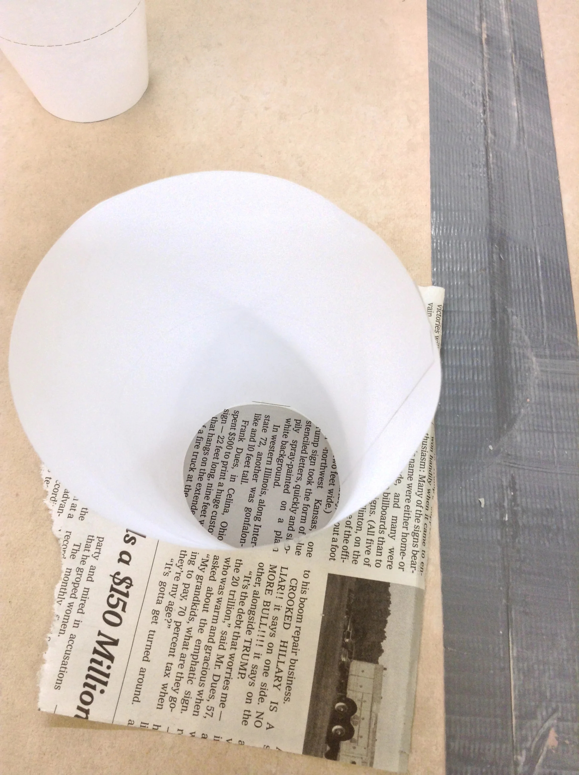Single paper cone, taped, as outer shell for containing slip.