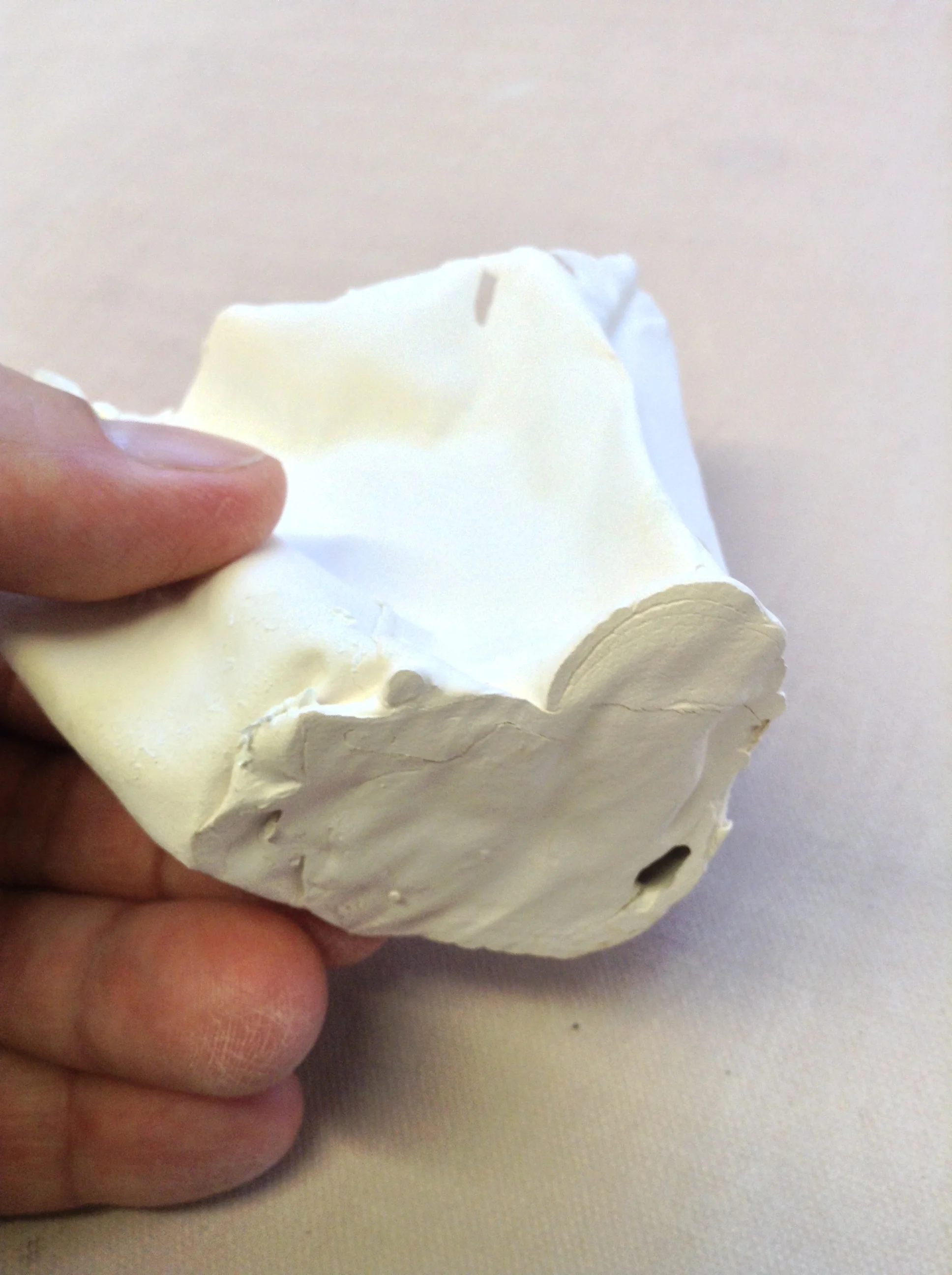 Bottom layer created by pouring slip into collapsed form while balanced on newspaper. Hole is accident, but interesting!