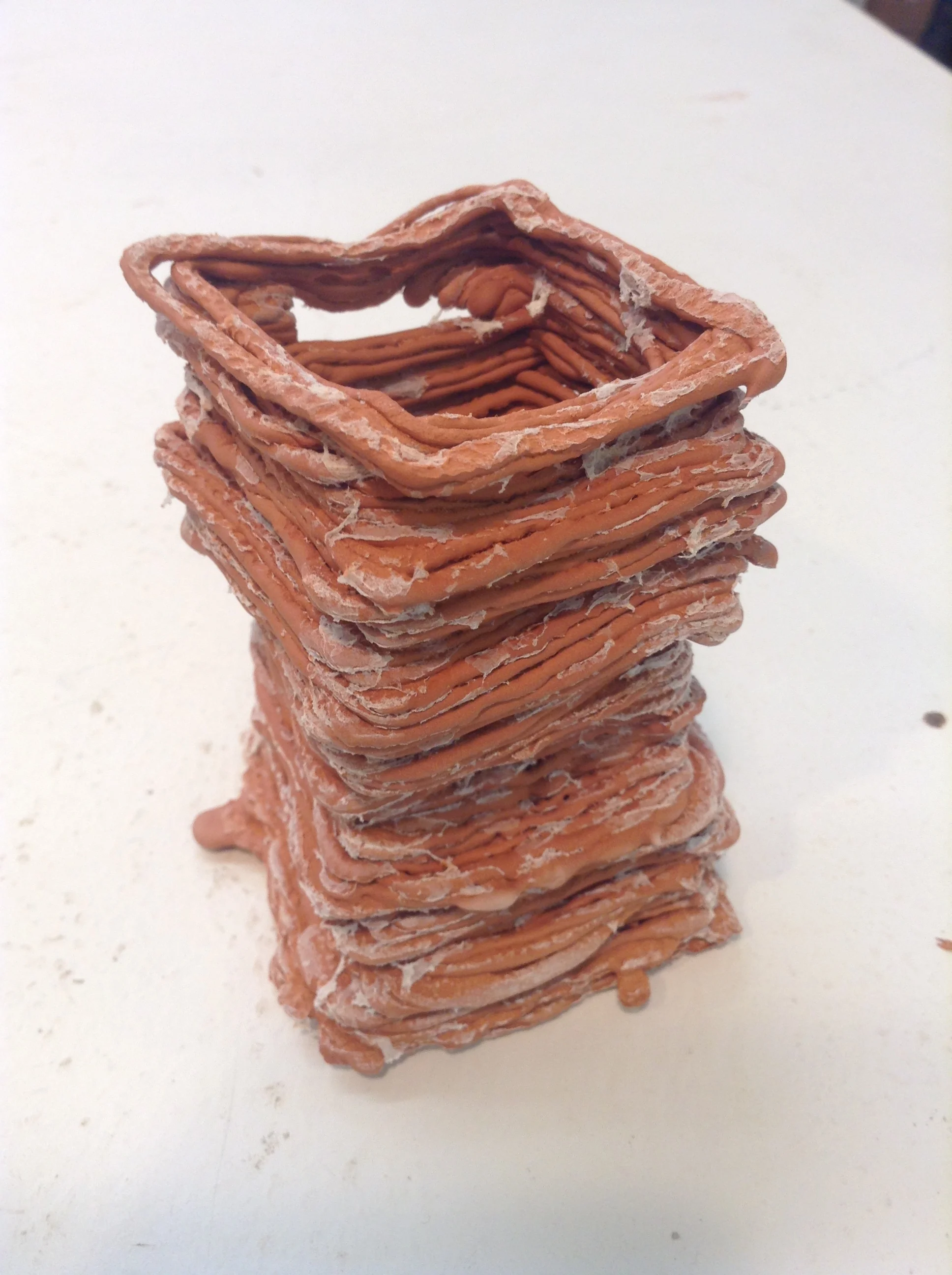 Stacked form just out of the kiln with white ash residue from burned-off paper napkin layers. This was brushed off easily.