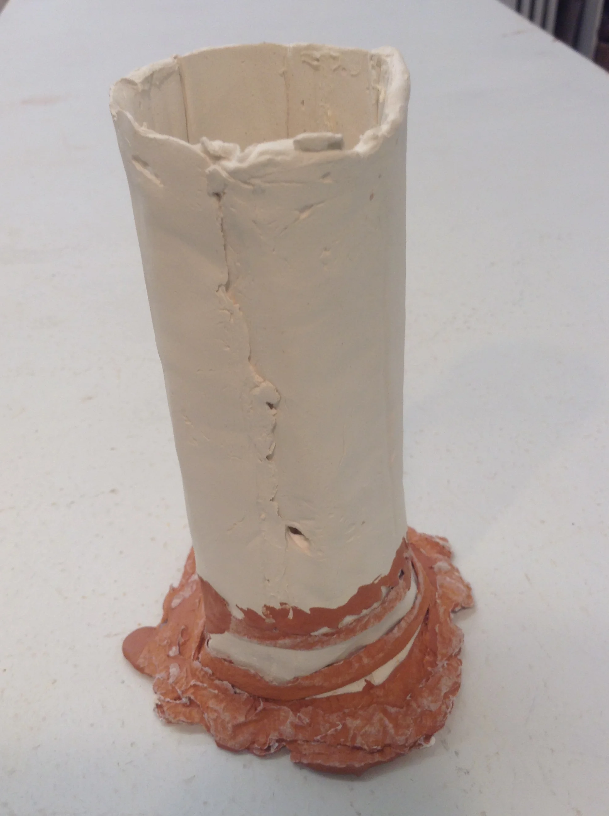 Single tube form made with two commercial casting slips (white and red) that have vinegar added for greater stiffness. The white clay got more vinegar for frosting-like consistency, and the red clay got only a little vinegar, just enough to slightly thicken it from its runny version as is comes as normal casting slip.