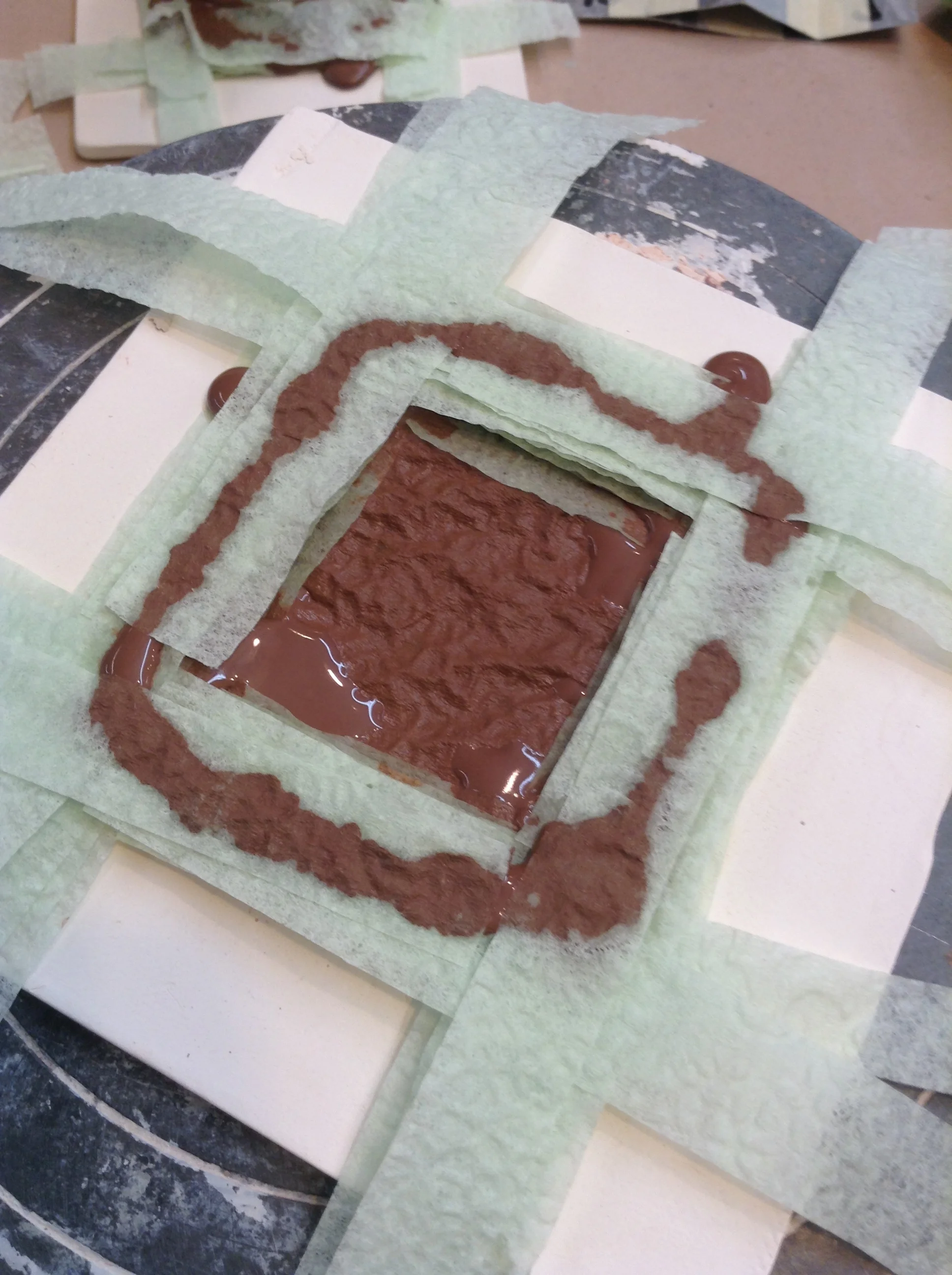 A few layers of square shaped pathway stacked on top of the solid base. Here the clay paths are supported by thin napkin strips because I wanted to find out if an open center would be easier to manage or would dry faster. Maybe, but the solid napkin square used as a layer is much faster. I'm particularly fond of the dimpled texture of the bottom layer that happens when the napkin embossing wrinkles up. (I can't prevent it anyway!)