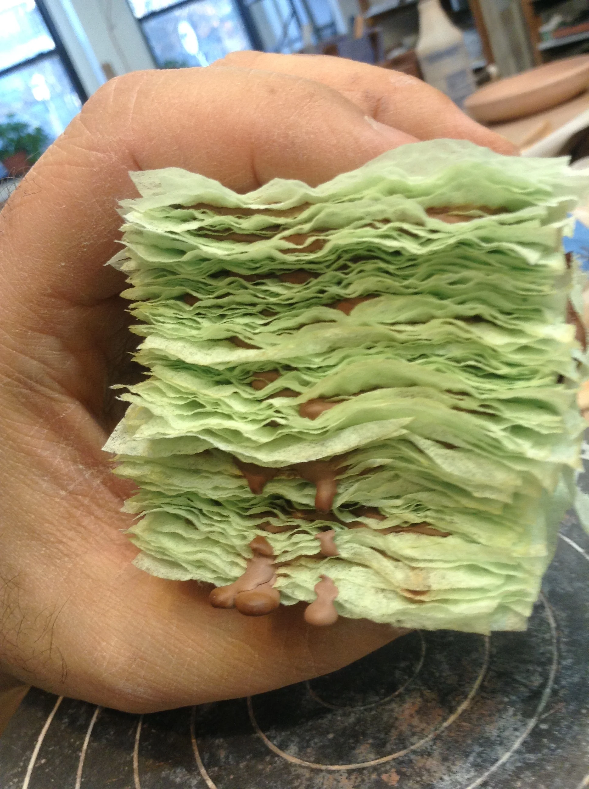 Several inches viewed from the side. It's fascinating! It's almost a pity the paper has to burn away. Maybe there is yet another sculpture technique that allows this effect to be permanant? Non ceramics, perhaps? Cloth squares glued together with caulking?