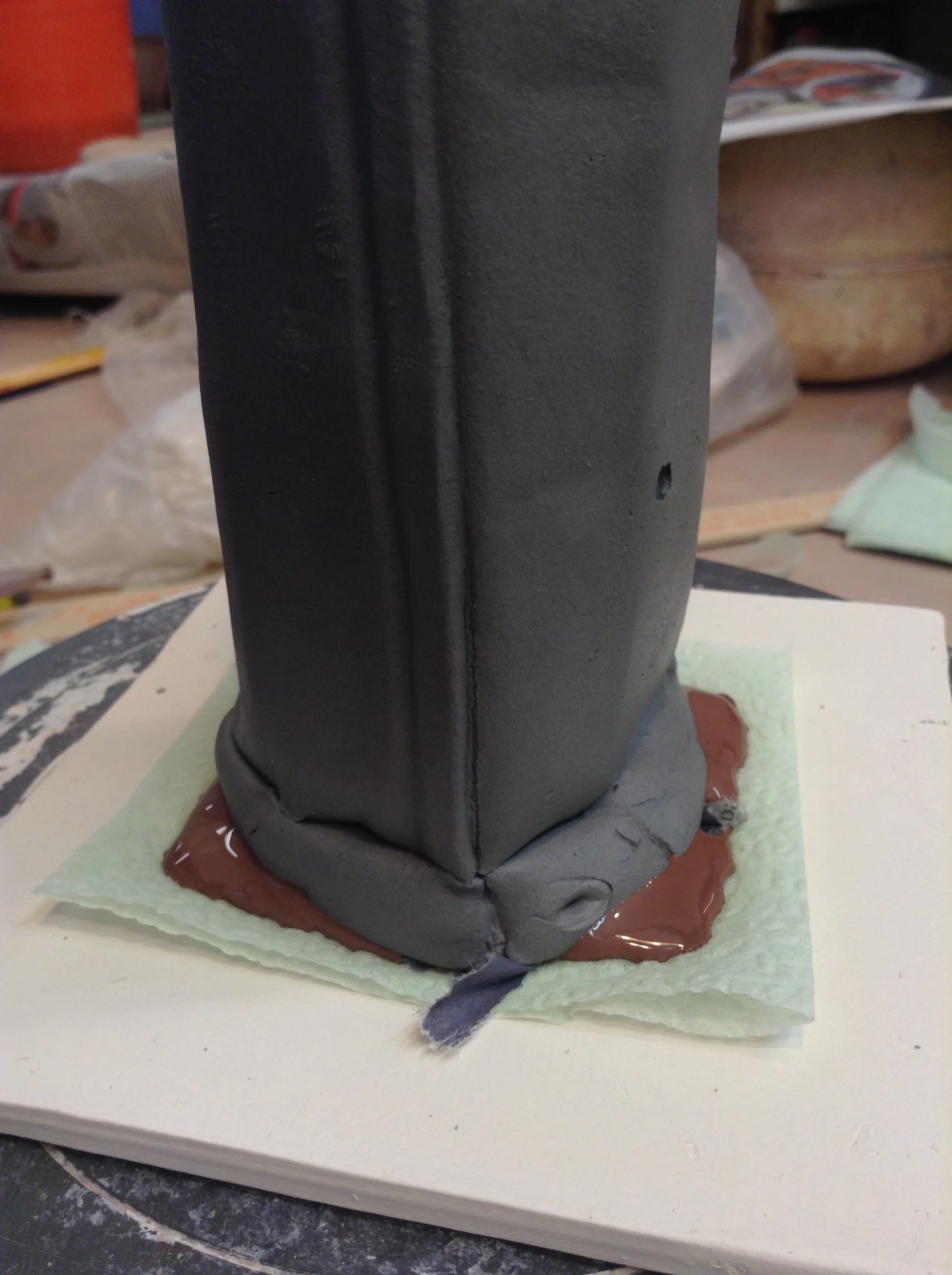 The white paste form has been quite literally squashed down onto the thickened slip base. It connects perfectly, and sets up pretty quickly in case I have to move the sculpture around.