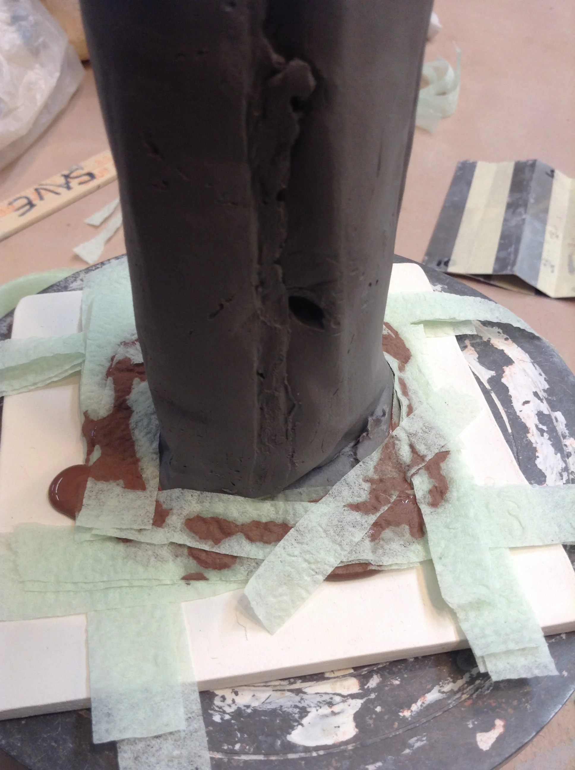 This strips of napkin tissue added at angles closer to tube than a square can get. Not sure using the strips method is worth the effort here. But my future designs need this technique. The center form like the white one here would be decorated or structurally changed by this slip trailed facade. 