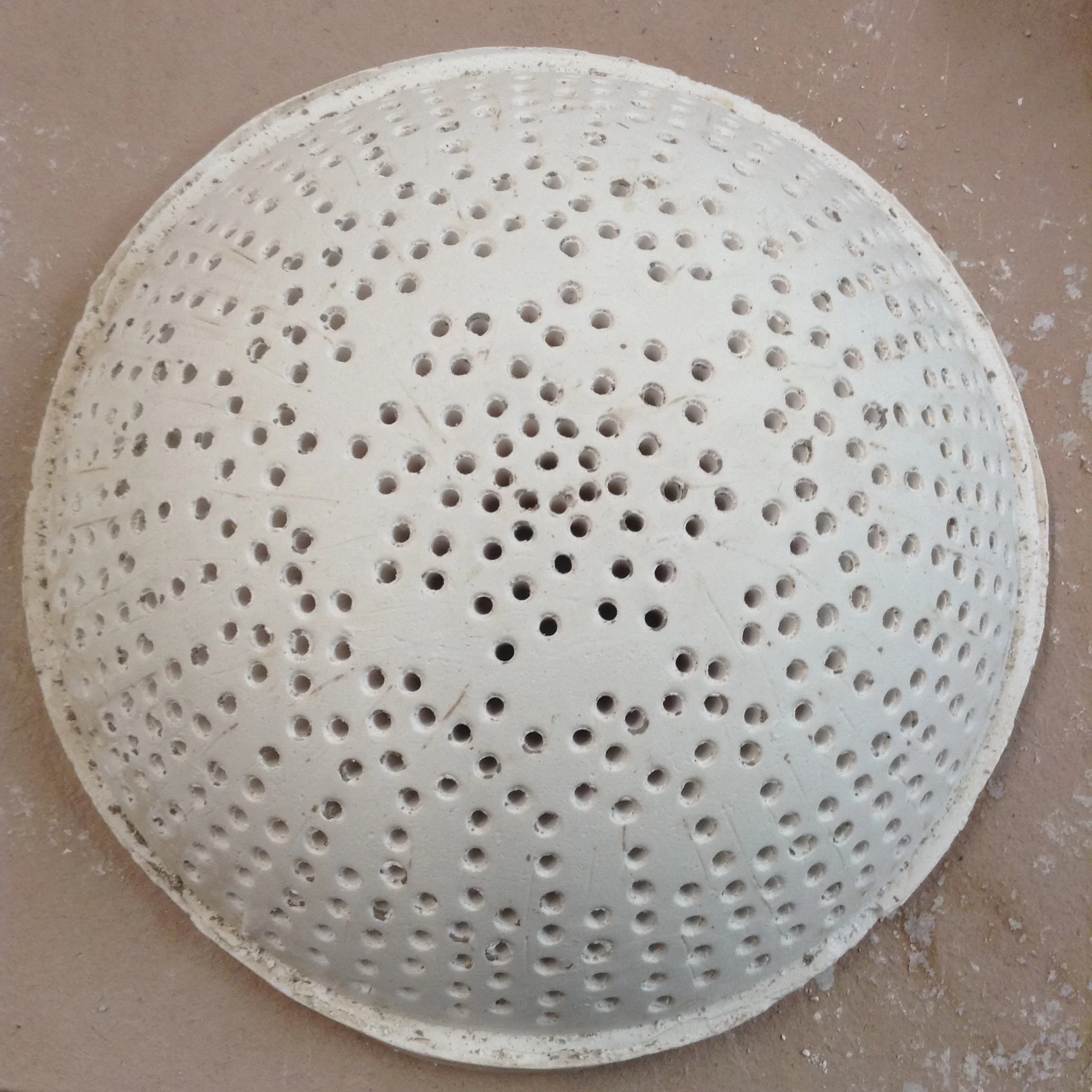 Large plaster dome form with different hole spacing in different areas.