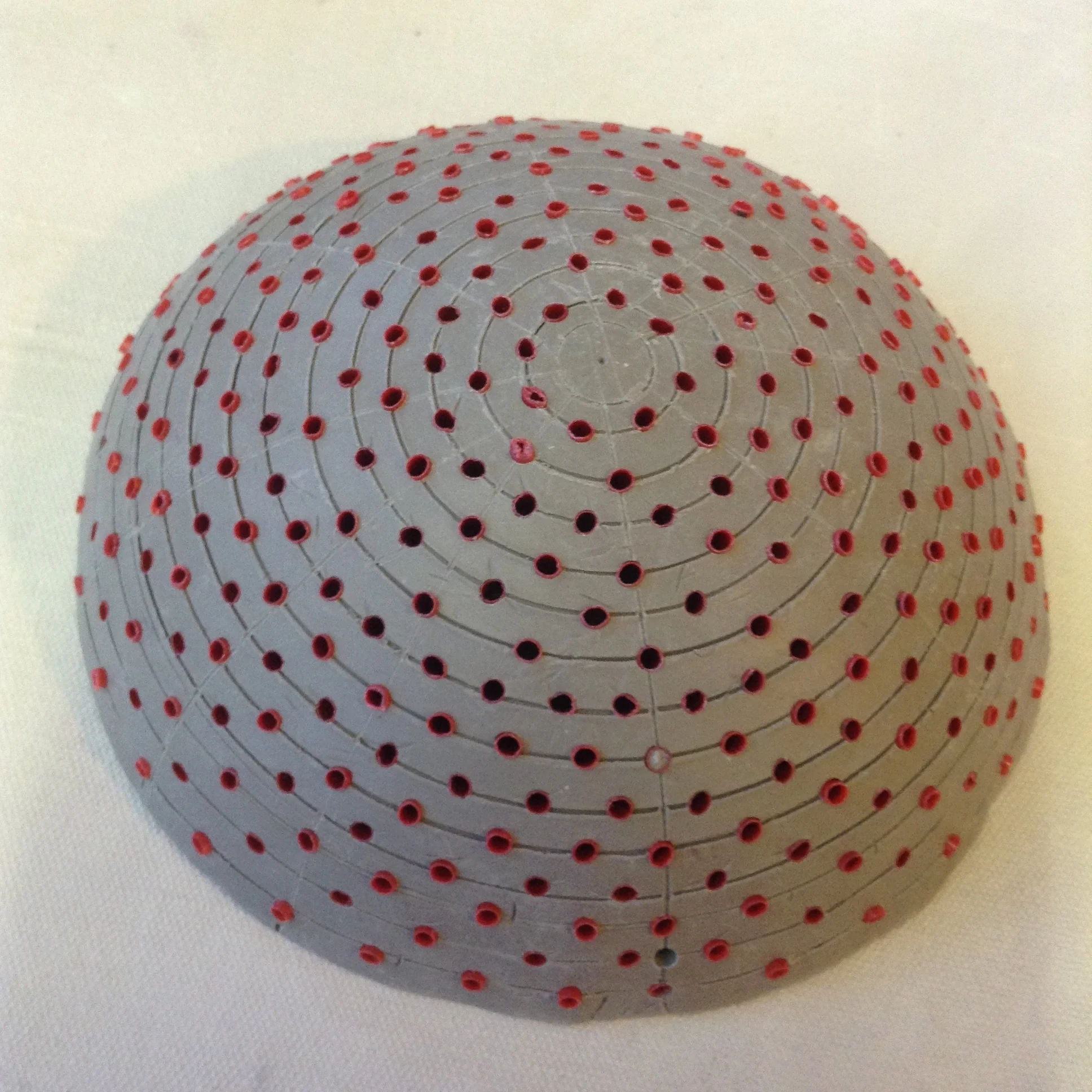 Example of the clay and straw pattern that will eventually become a plaster dome that holds nails for winding the strings that support the clay slip.