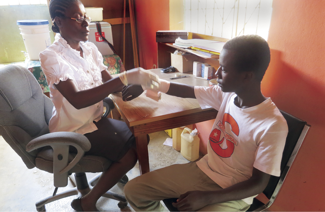 Marie Chantal Phillipe, the director of our medical clinic, cares for Richardson during a visit he made to our facility in Bire. 